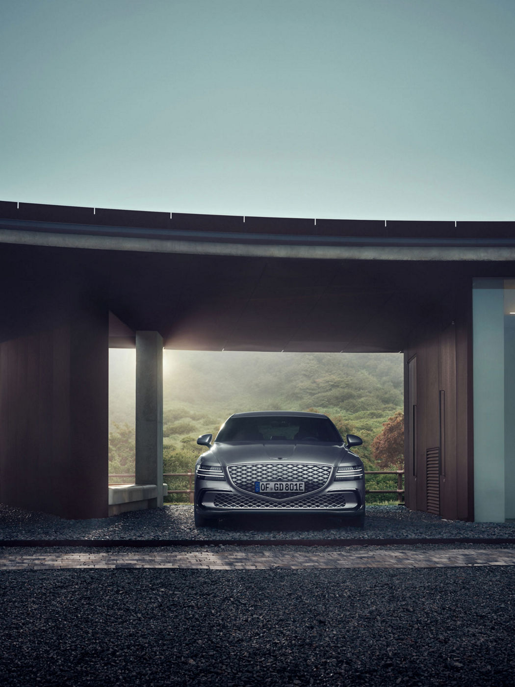 Exterior view of the Genesis Electrified G80 luxury electric sedan showcasing its design and distinctive lighting.
