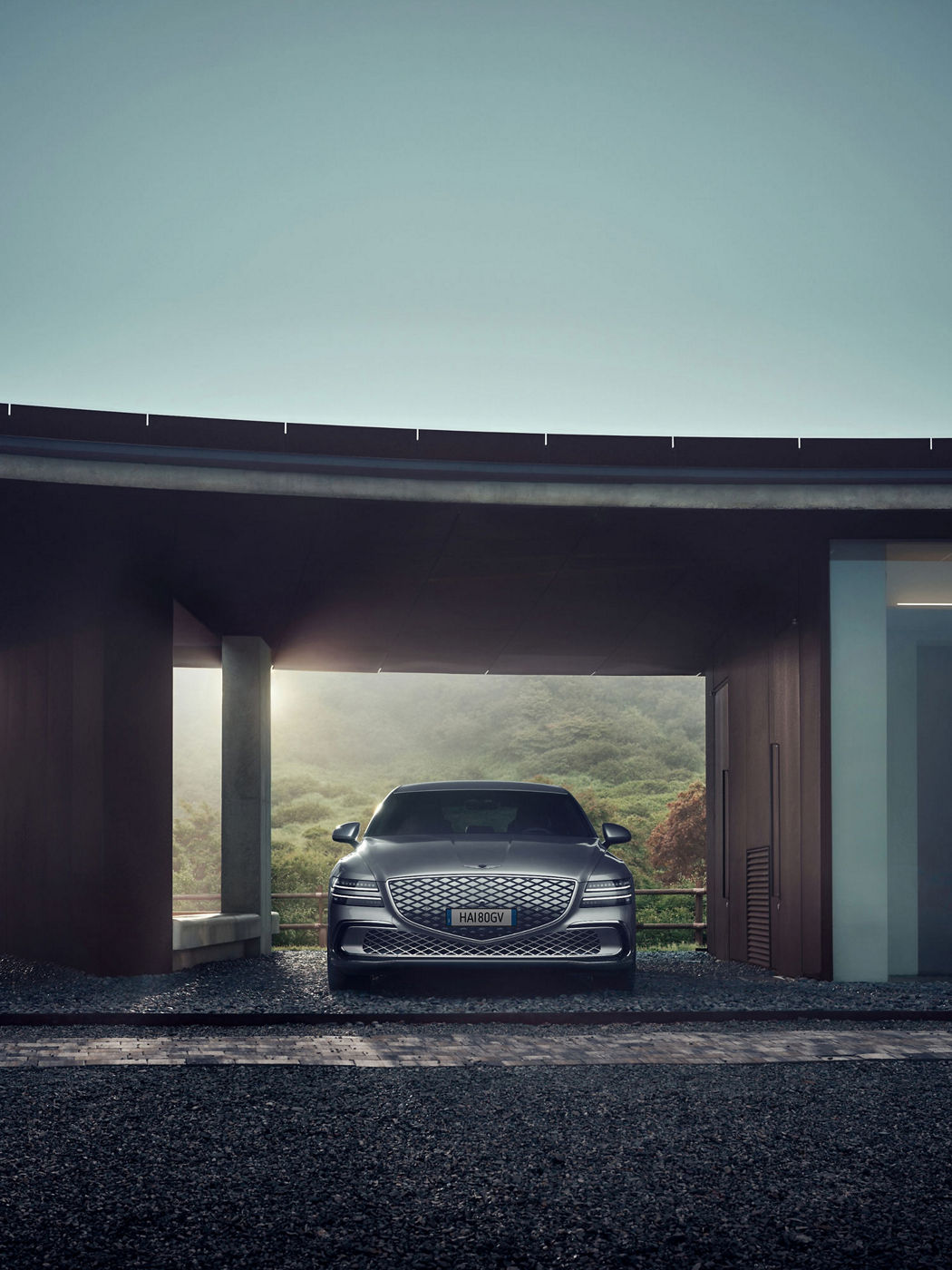 Exterior view of the Genesis Electrified G80 luxury electric sedan showcasing its design and distinctive lighting.