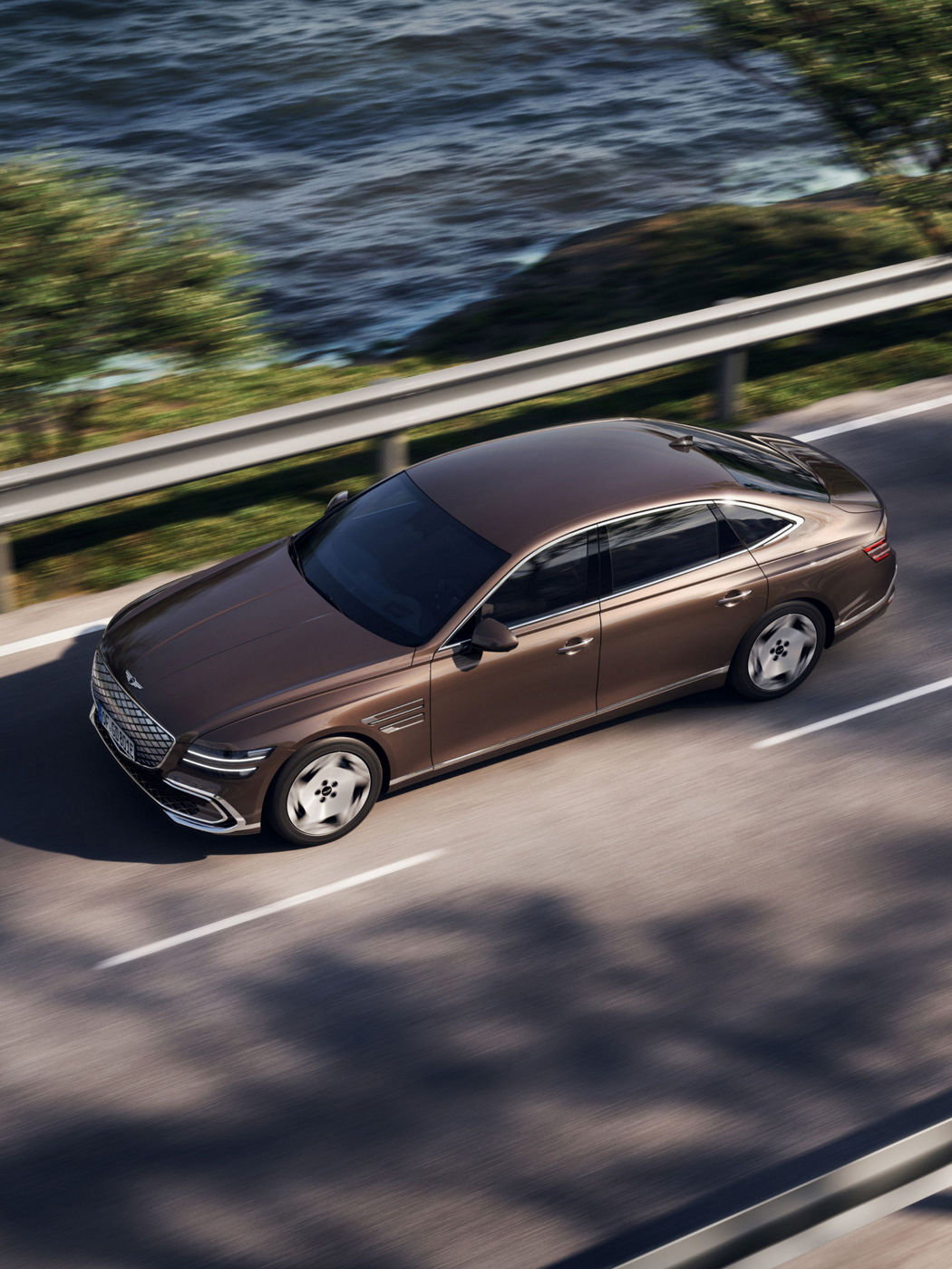 A Brooklyn Brown colored Electrified G80 is seen on the road.