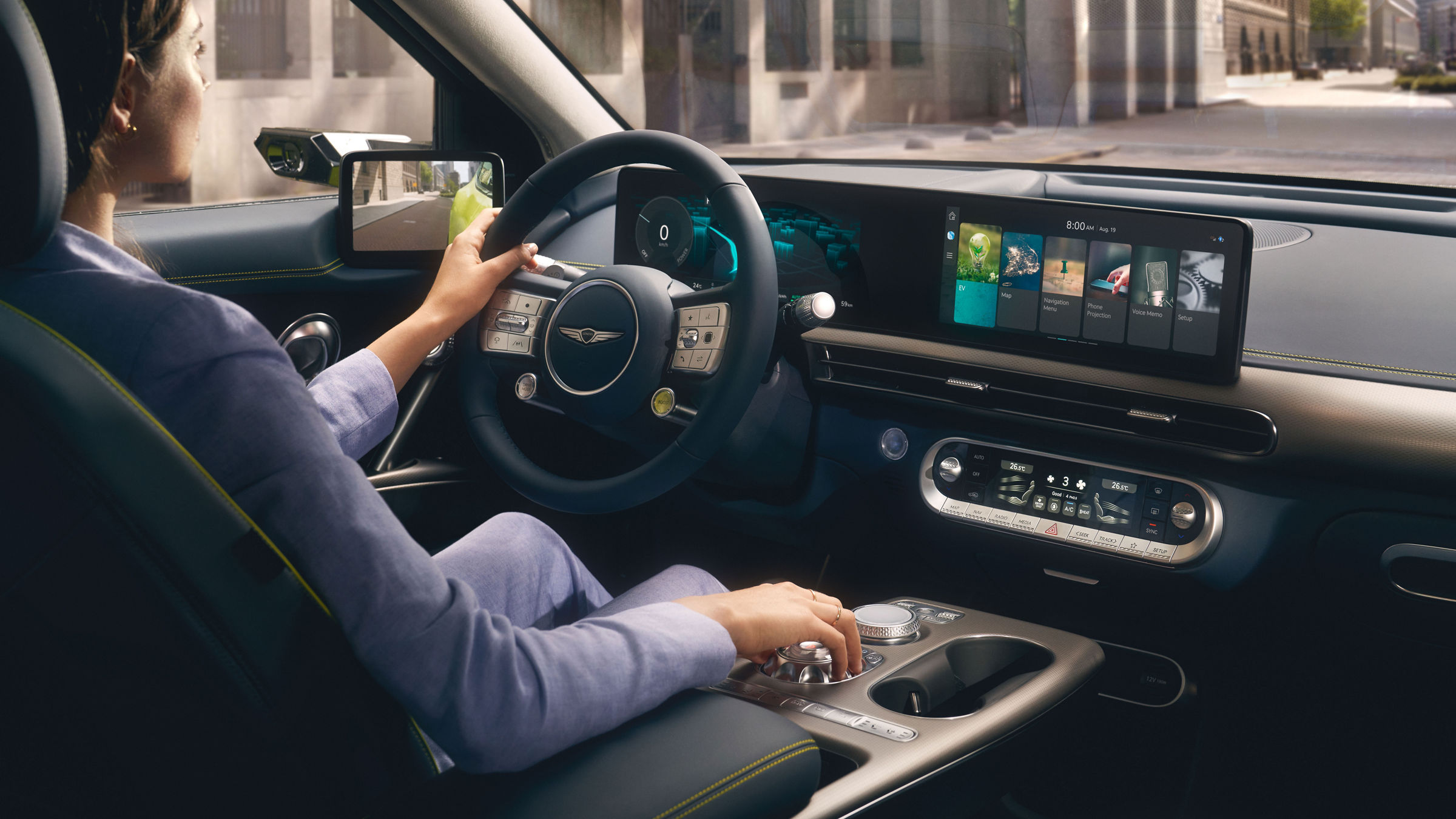 Woman at the wheel of a Genesis GV60 driving through the city - details of the dashboard