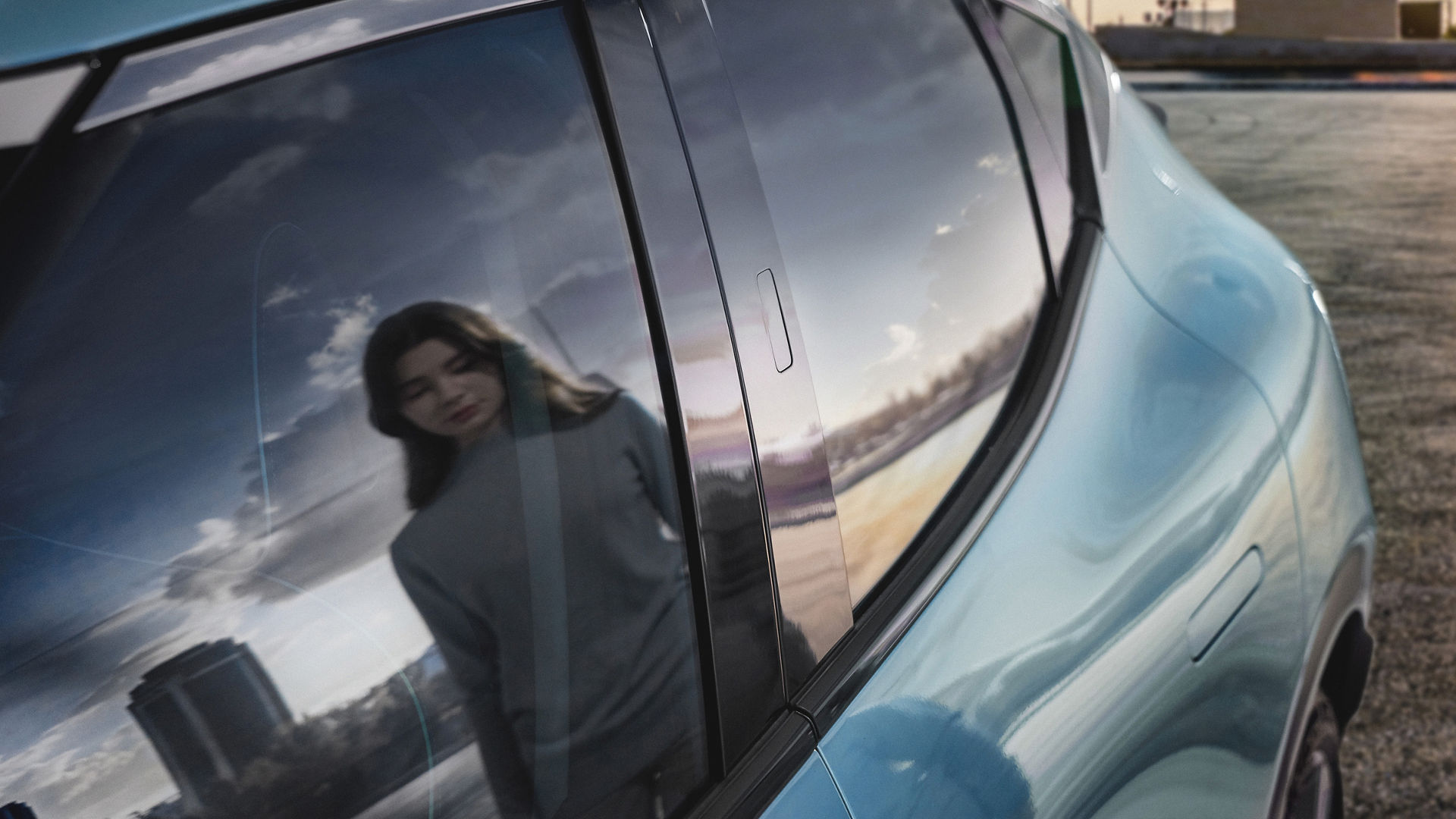 Reflection of a woman in the rear window of a car