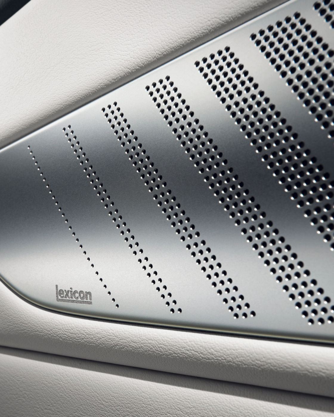 A close-up of the Electrified G80’s premium Lexicon sound system speaker grille with a sleek perforated design.