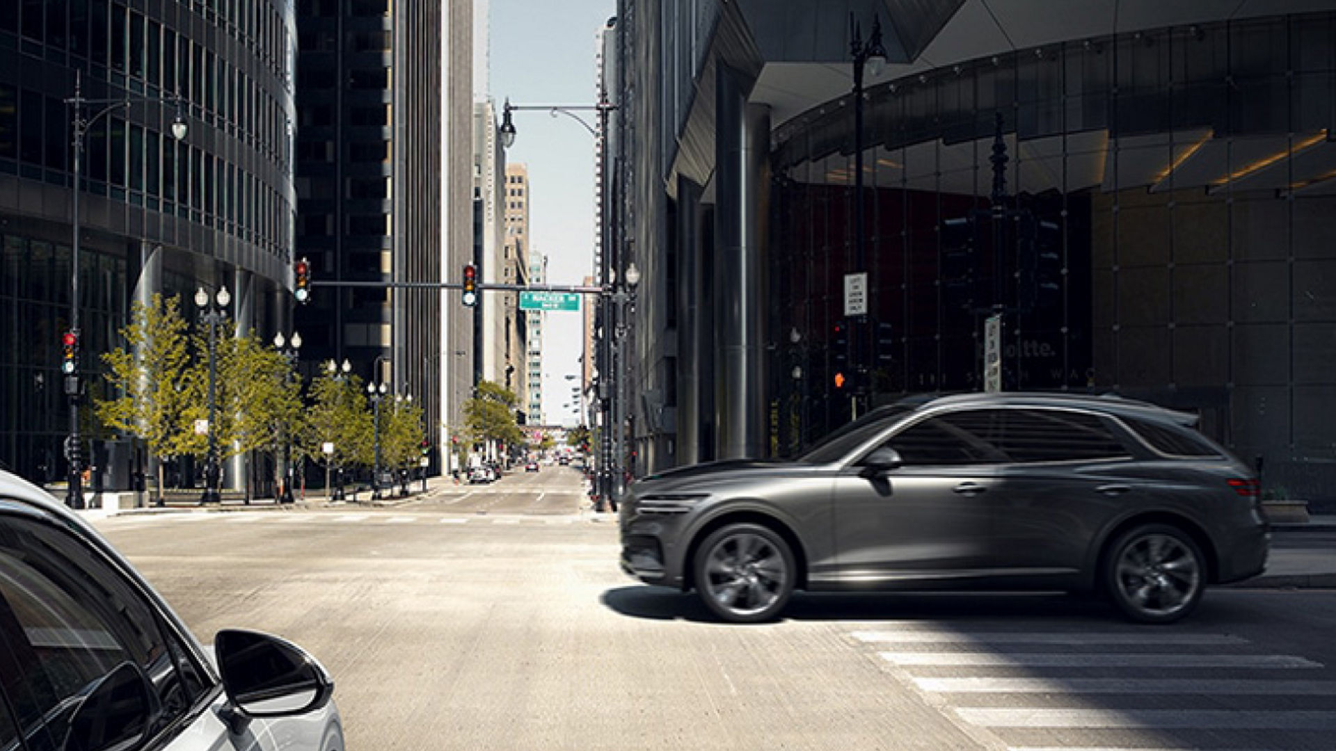 The Electrified Genesis GV70 navigating a bustling city intersection, highlighting its sleek design and urban versatility.