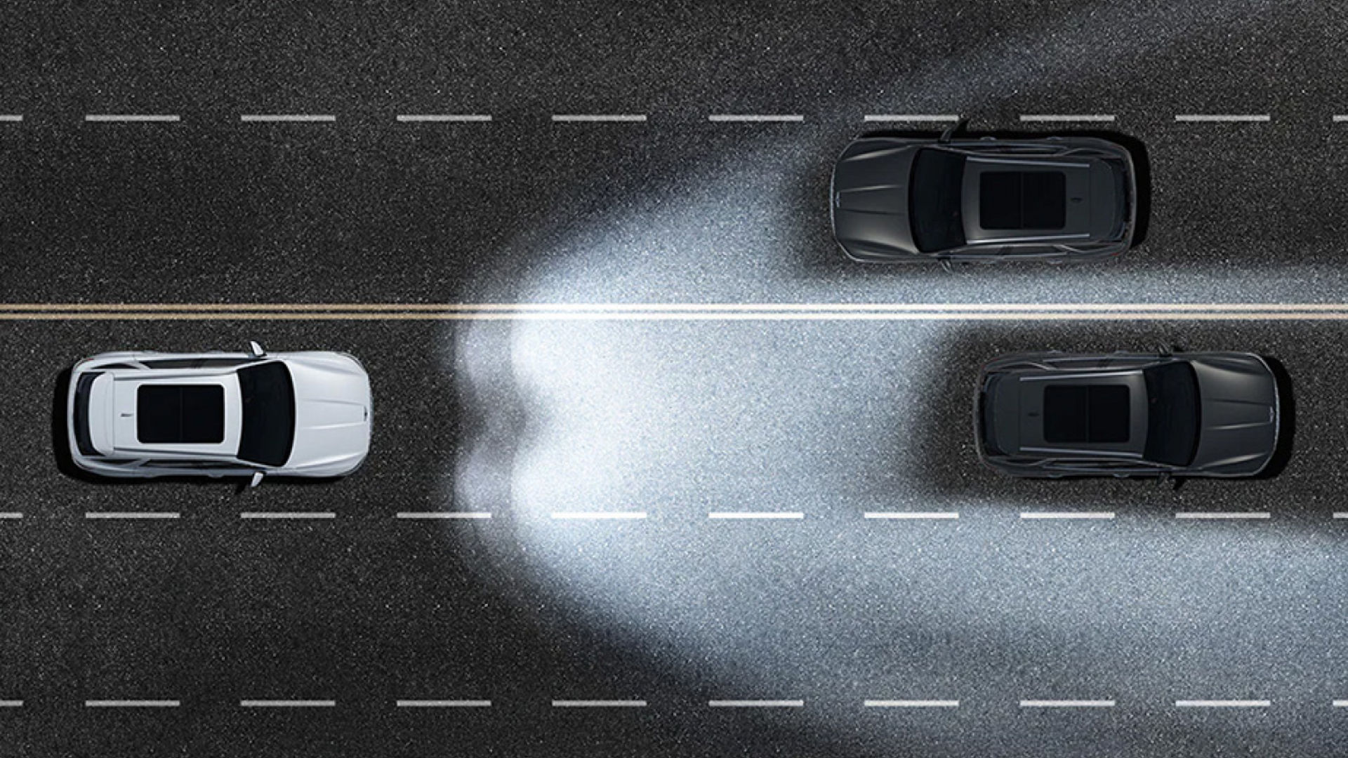 A top-down view illustrating the adaptive headlights of the Electrified Genesis GV70 illuminating the road while maintaining visibility for other vehicles.