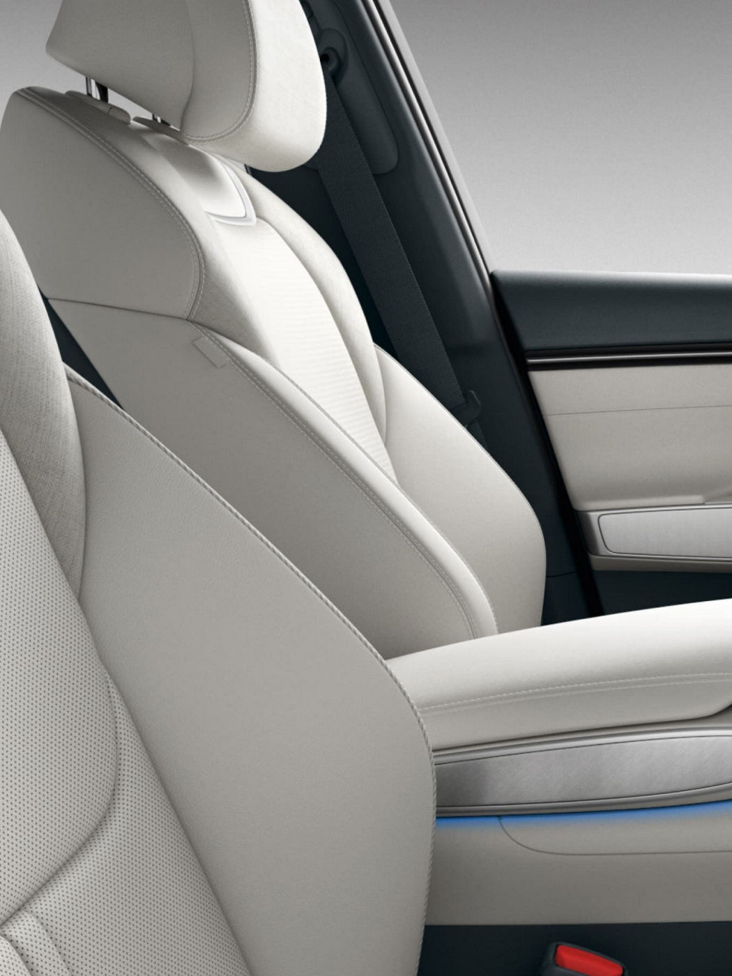 A view of the Genesis GV70's front seats, showcasing the white leather upholstery and refined stitching details.