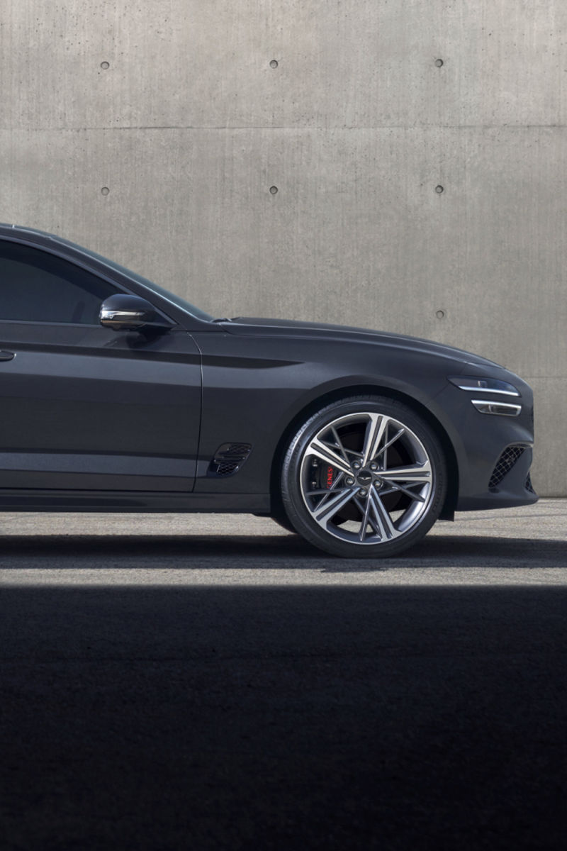 A side profile of the G70 Shooting Brake, with its distinctive silhouette against a minimalist concrete backdrop.