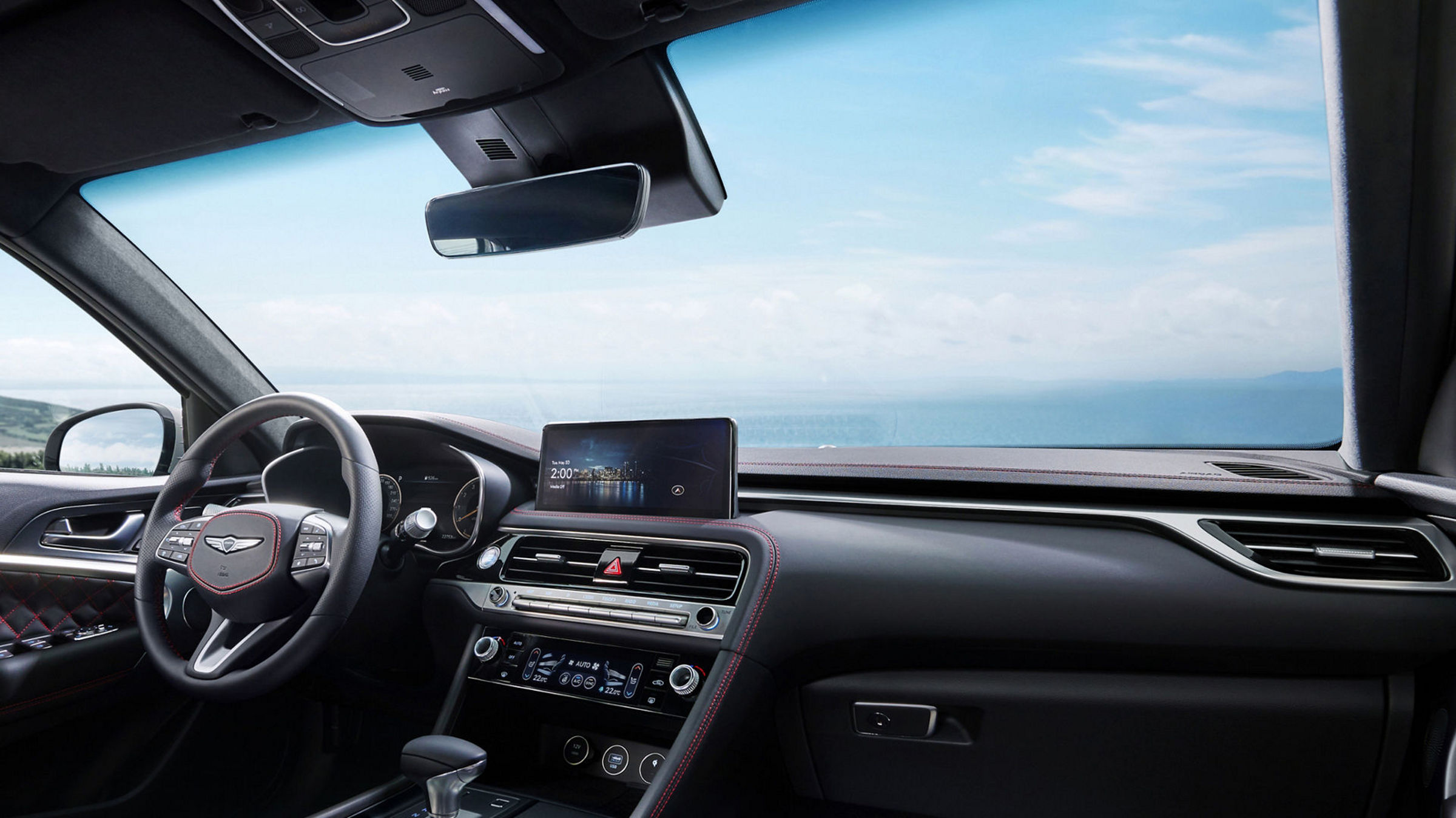 Close-up of the G70 Shooting Brake's steering wheel and dashboard, emphasizing its premium materials and intuitive controls.