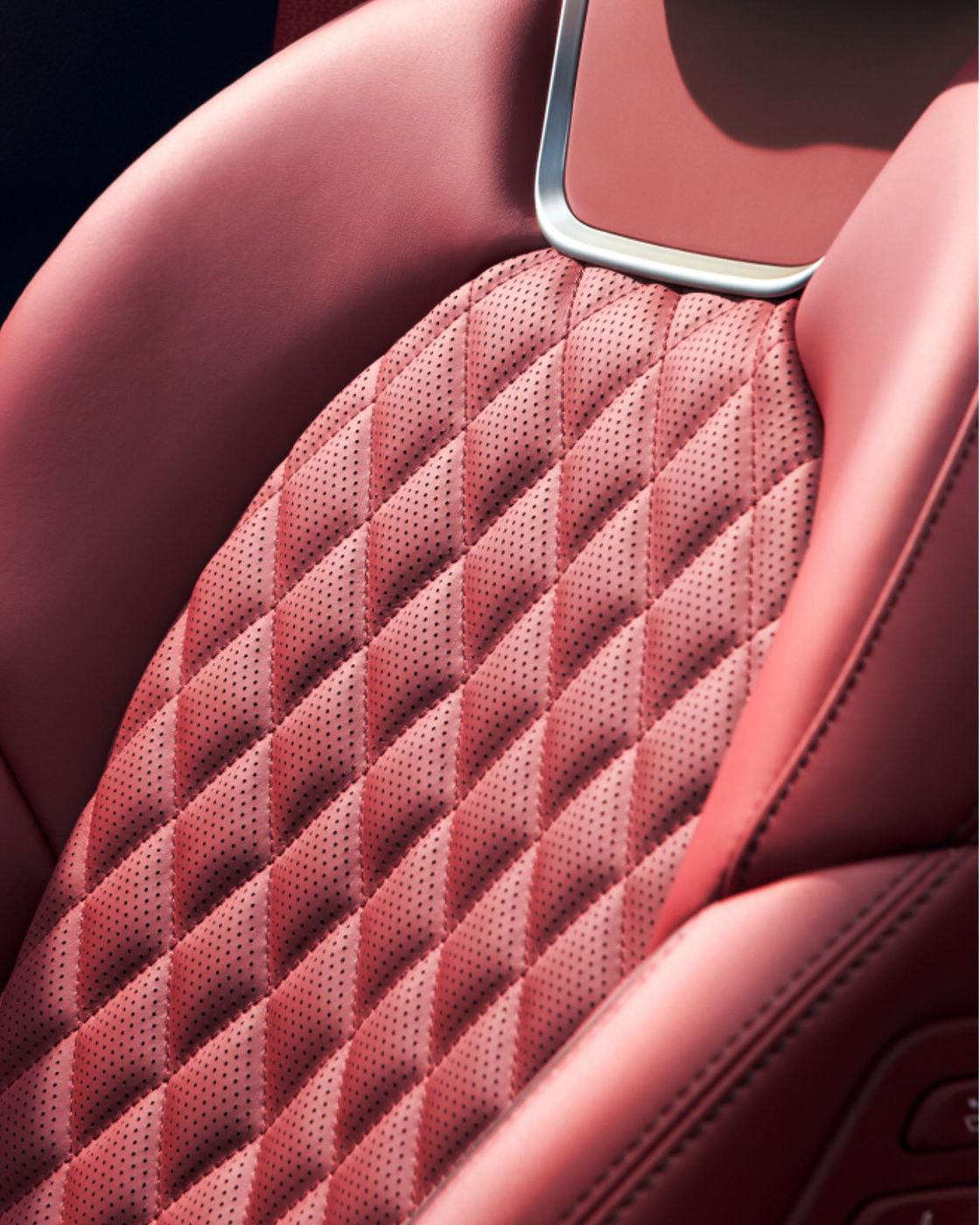 Close-up of the Genesis G70's red quilted leather seat.