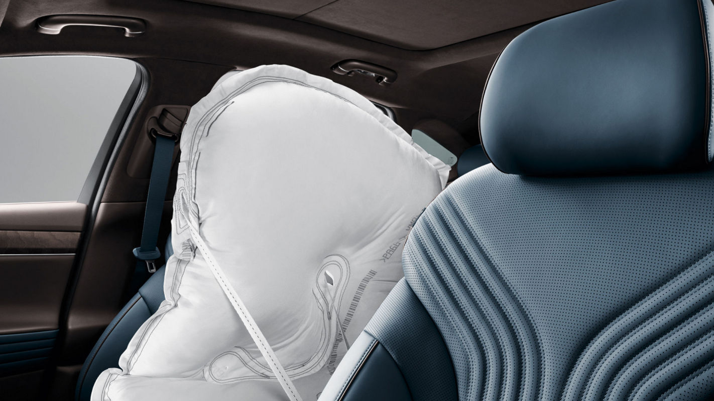 Blue driver's seat of a car with activated side airbag.