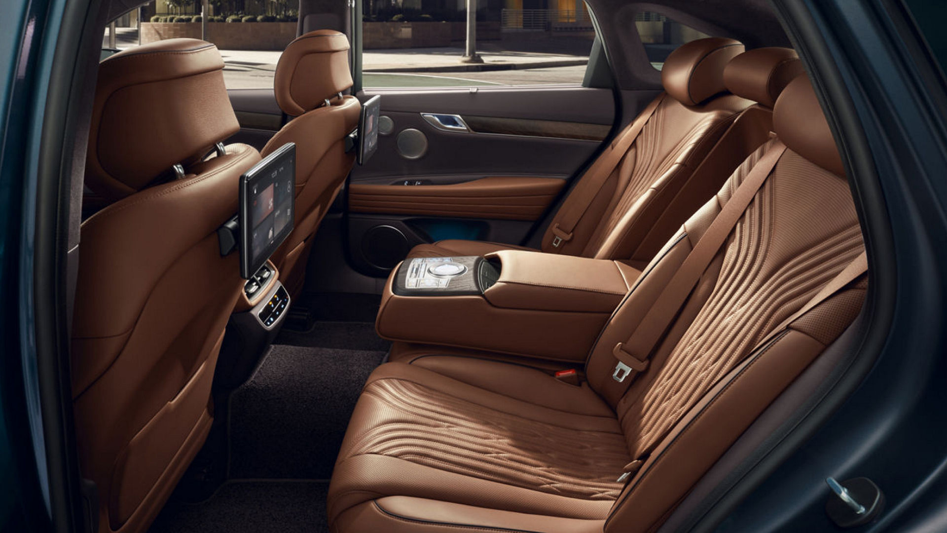 Luxury interior of G80 with adjustable rear seats in brown leather.