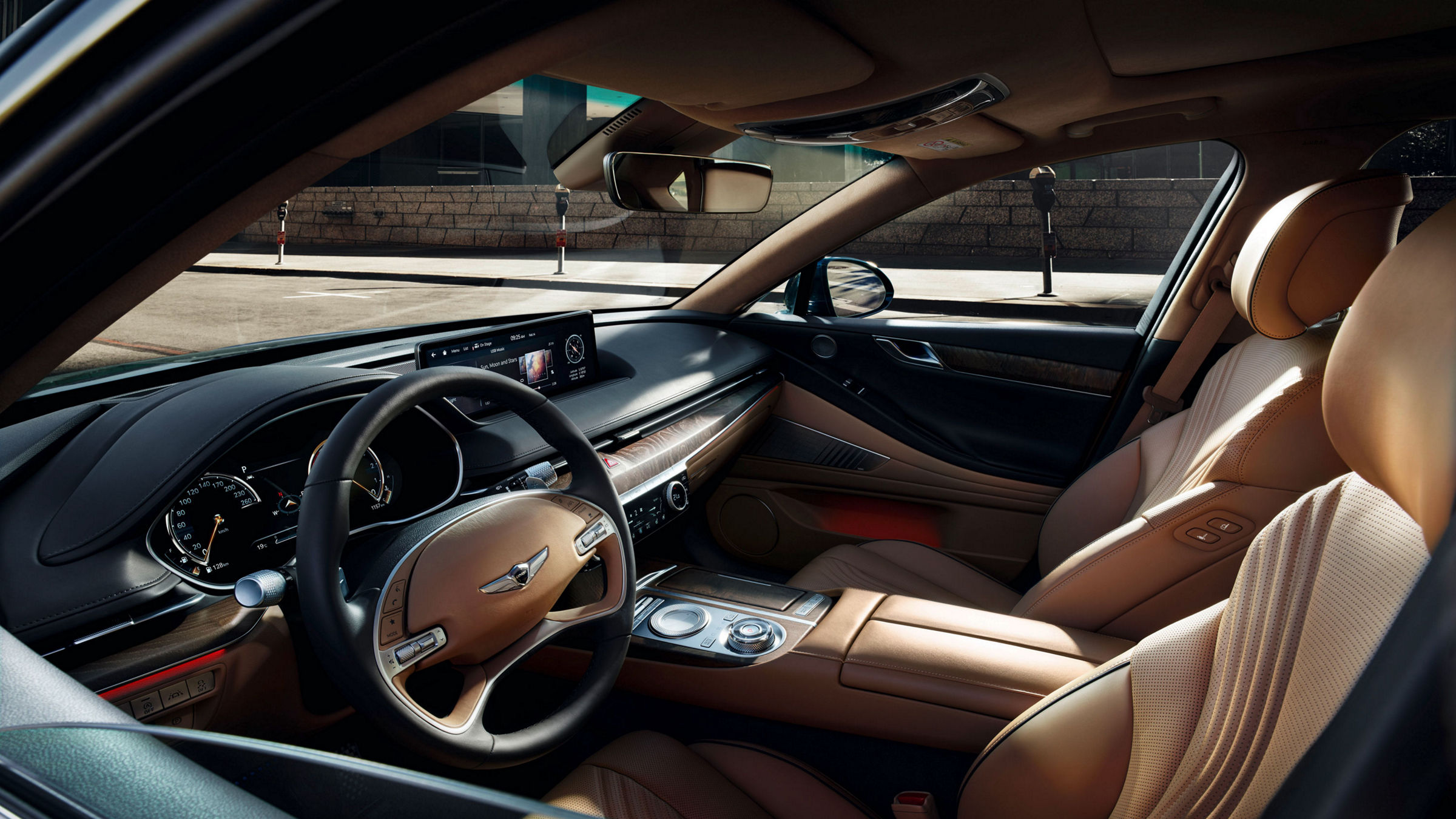 View through the window of the front compartment of the Genesis G80 with beige and black interior