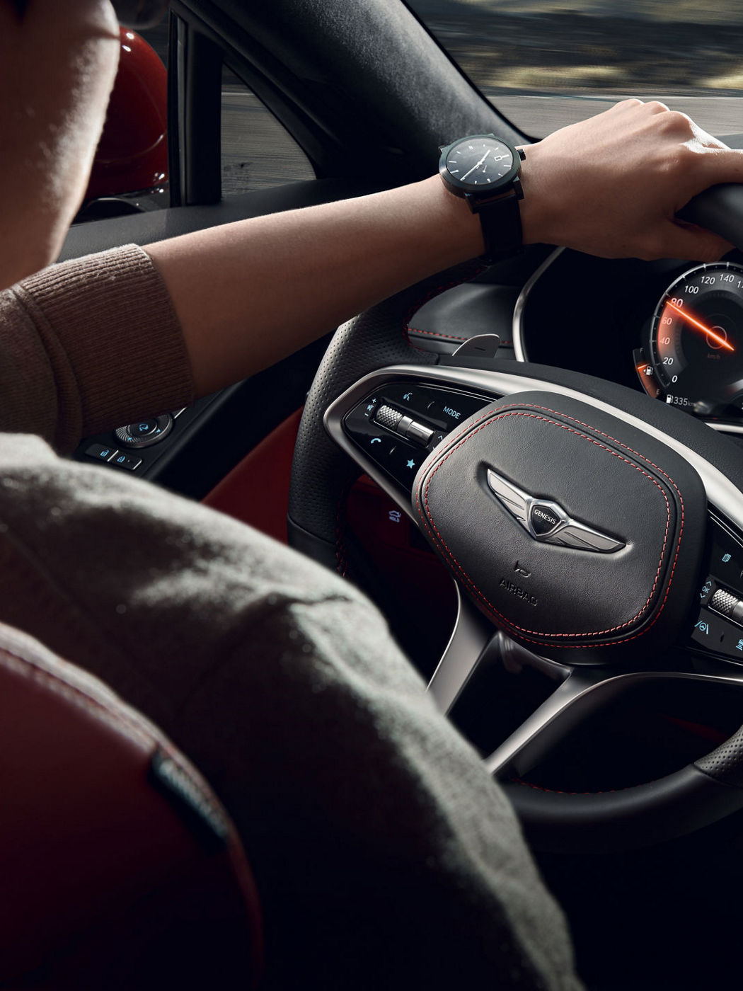 A close-up of the G80's steering wheel, featuring the digital dashboard and meticulous leather finish.