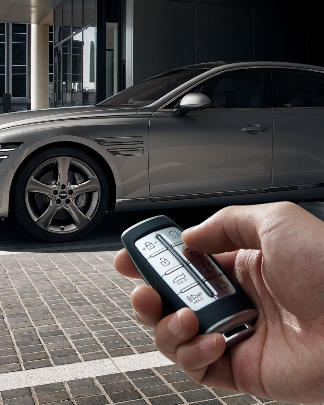 Genesis G80 shown with Remote Parking Assist feature, highlighting the key fob in the foreground.