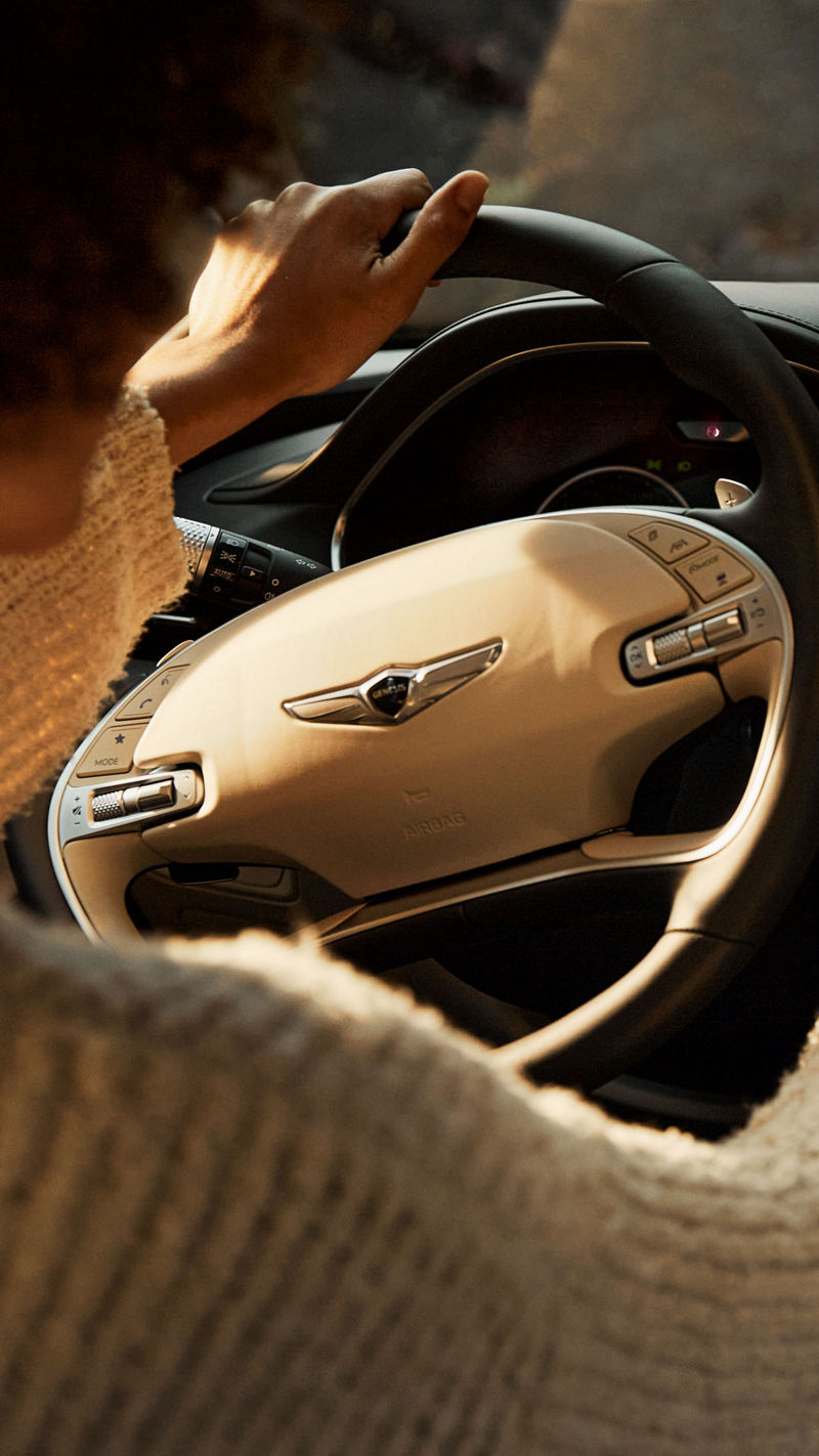 Looking over the shoulder of a person at the wheel of a car