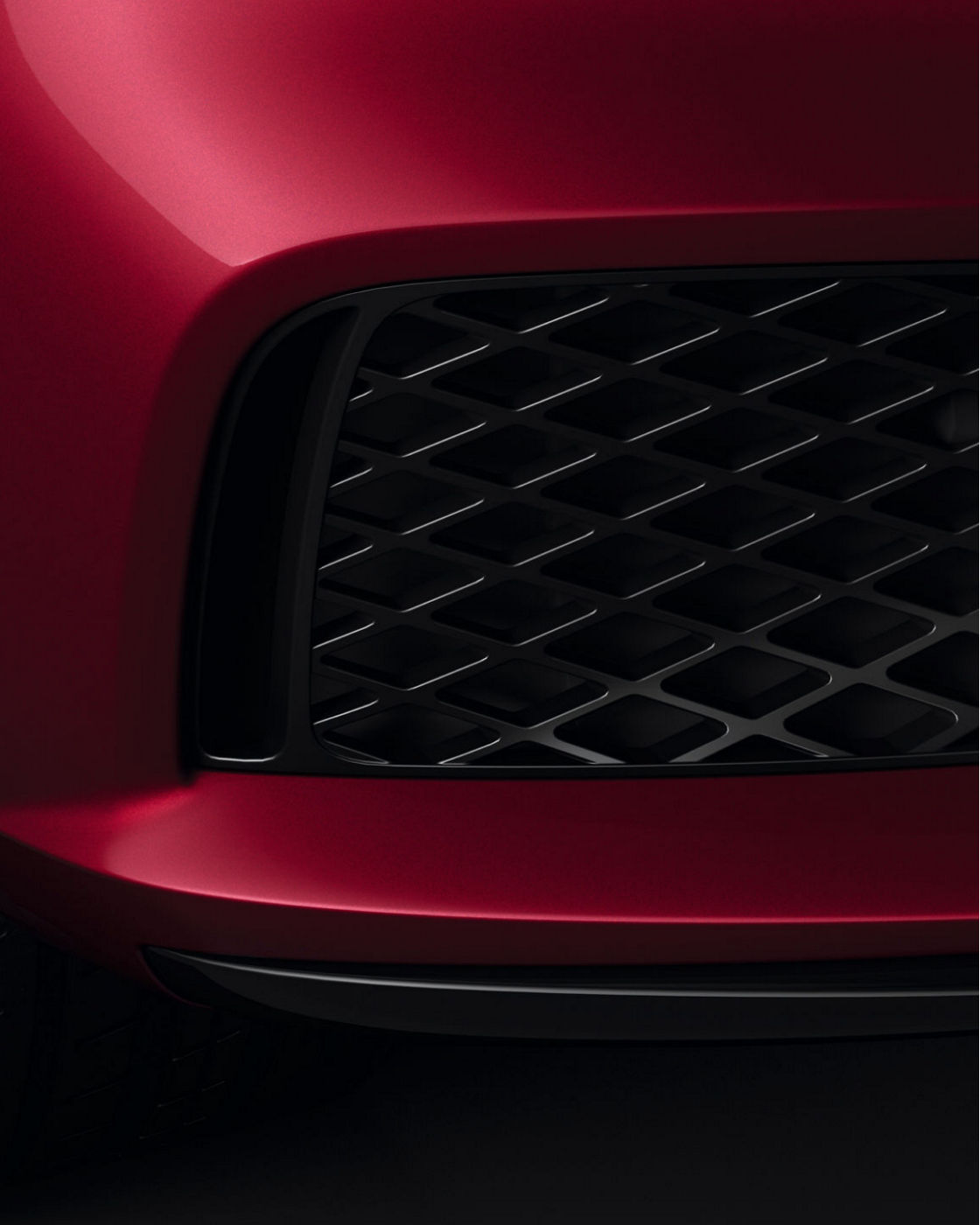 Front view of the Genesis G80 Sport in red, showcasing detailed design.