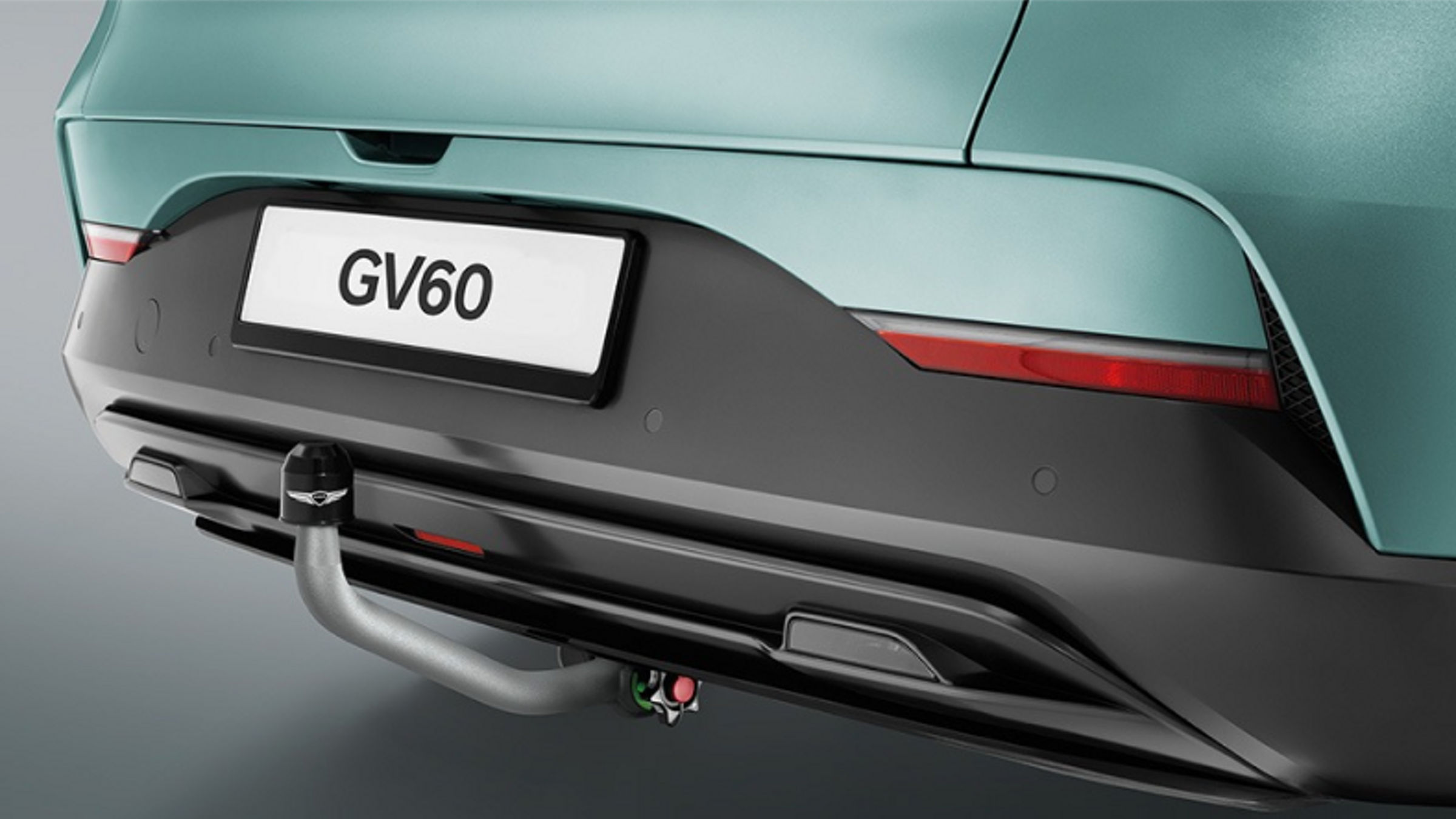 Close-up of the GV60's rear bumper and tow hitch, showcasing its functional design