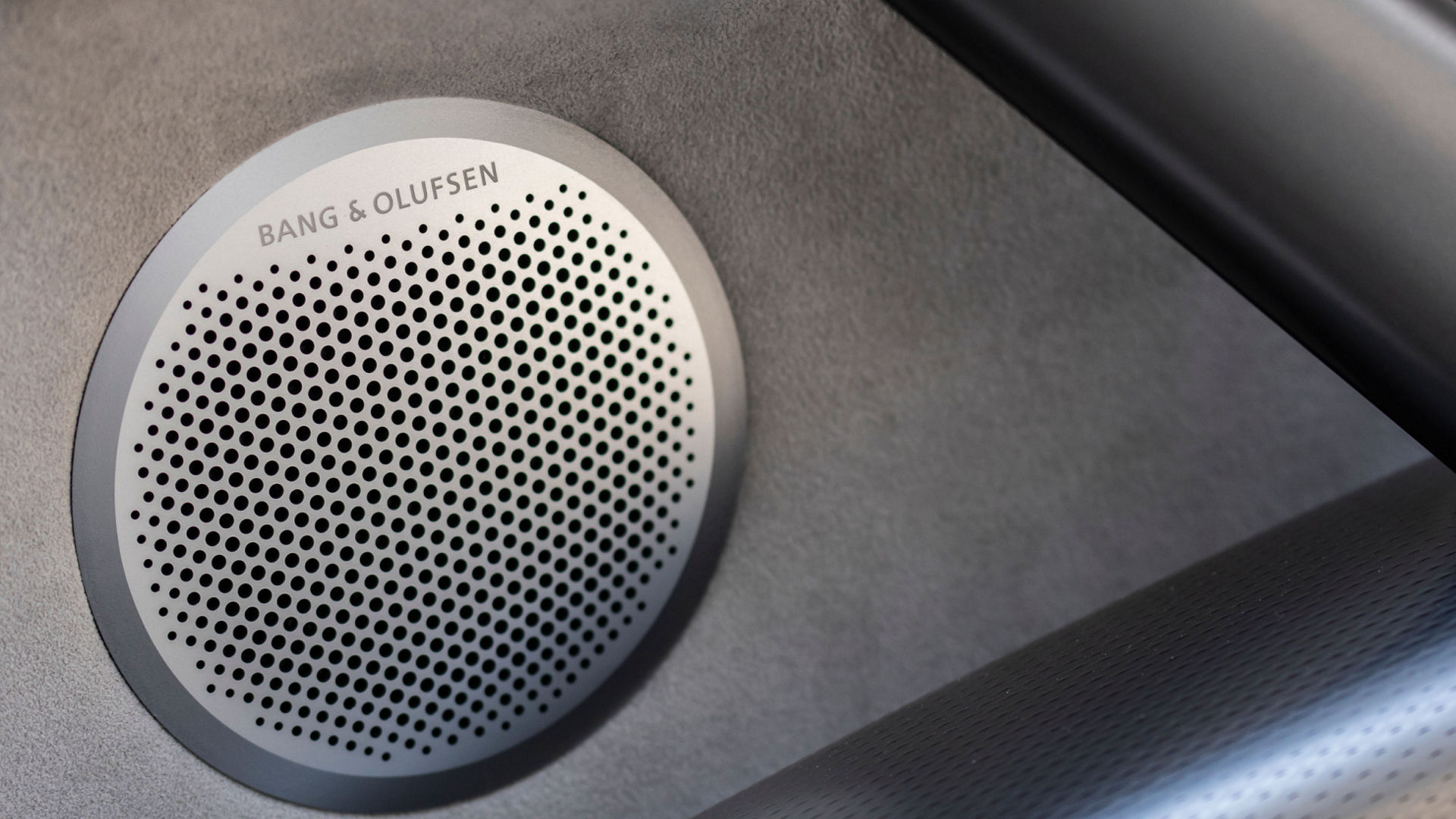 A vehicle speaker featuring the Bang & Olufsen sound system, known for high-quality audio.