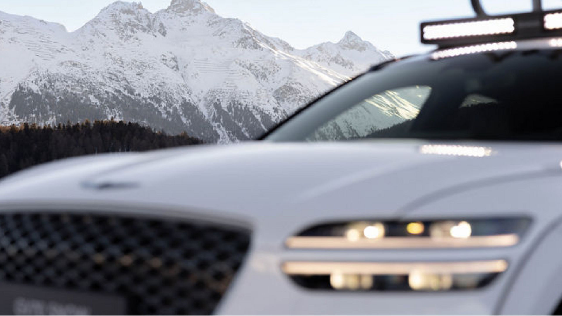 Genesis GV70 Snow Concept with snow-covered mountains in the background