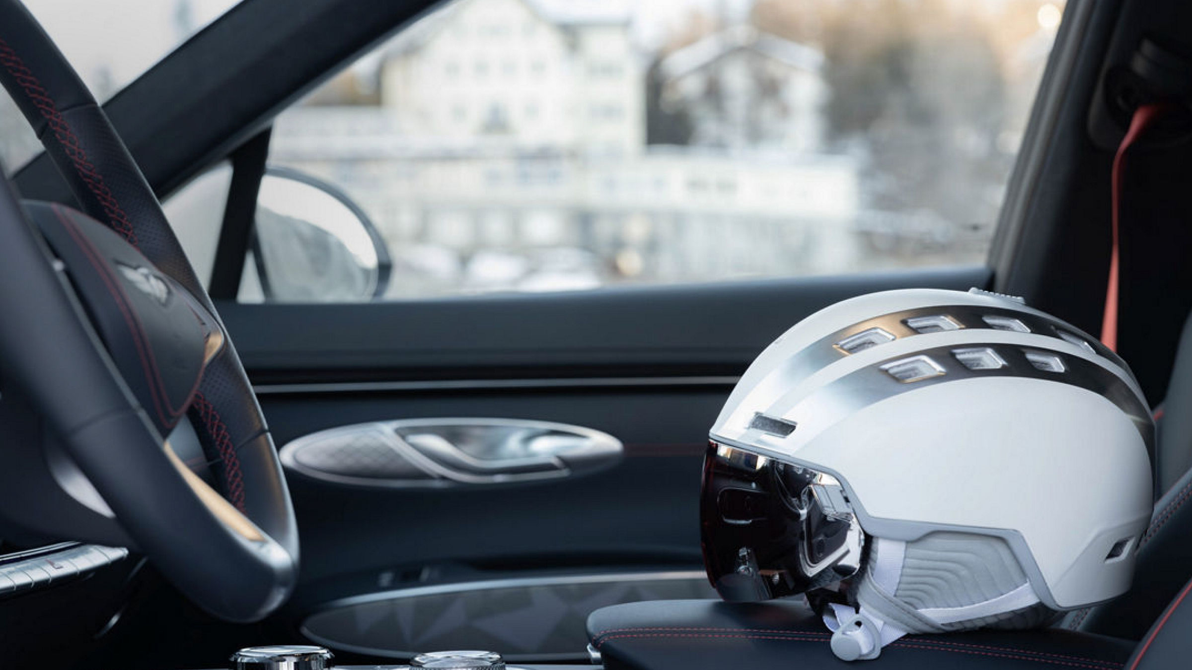 Interior of a Genesis GV70 Snow with a white helmet on the seat