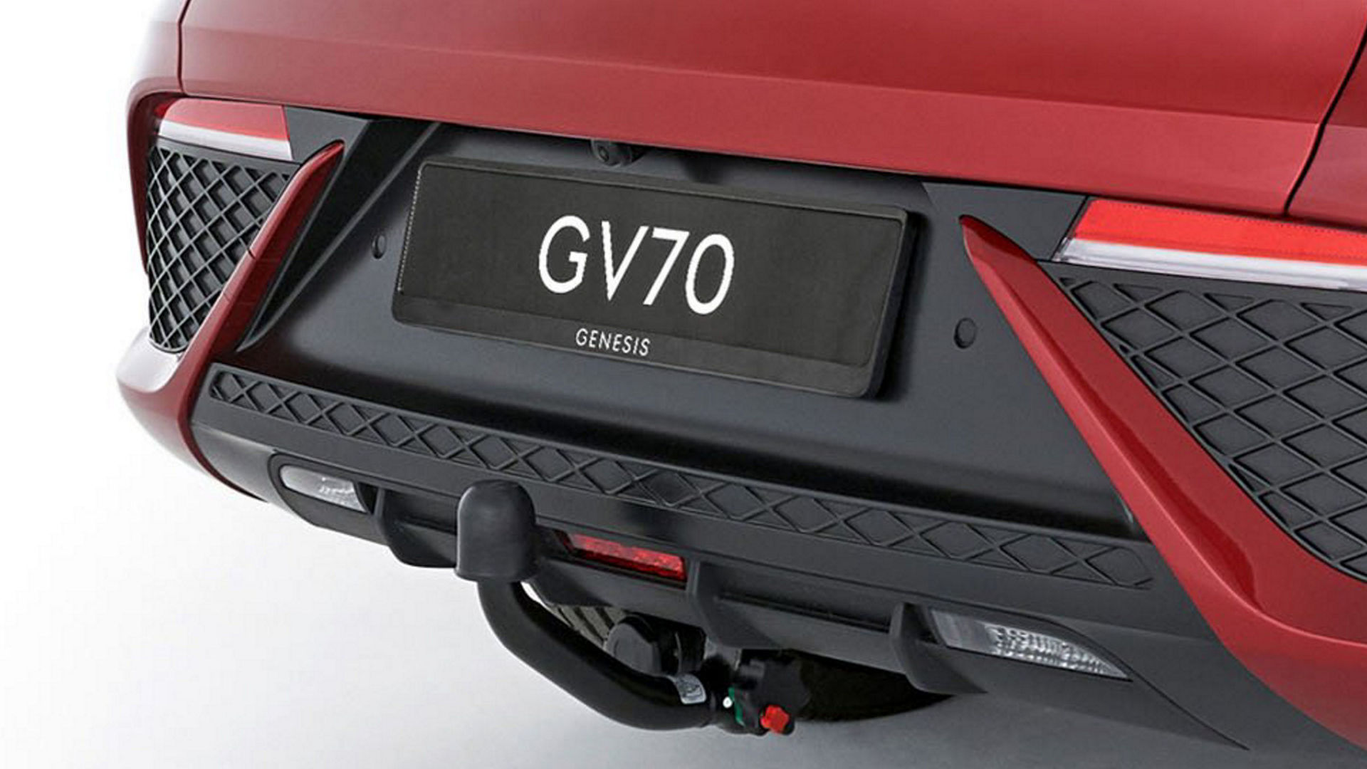 The Genesis GV70 features a stylish and functional tow hitch, seamlessly integrated into the rear bumper for both utility and aesthetics.