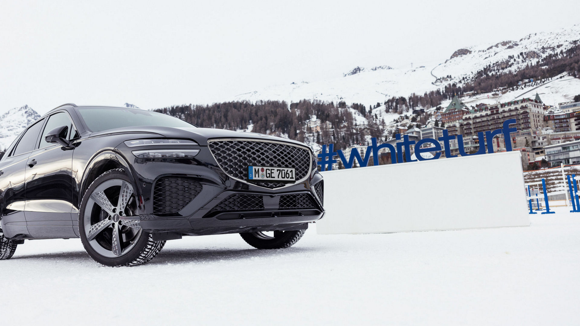 The Genesis GV70 stands boldly in a snowy alpine landscape, embodying luxury and performance in winter conditions.