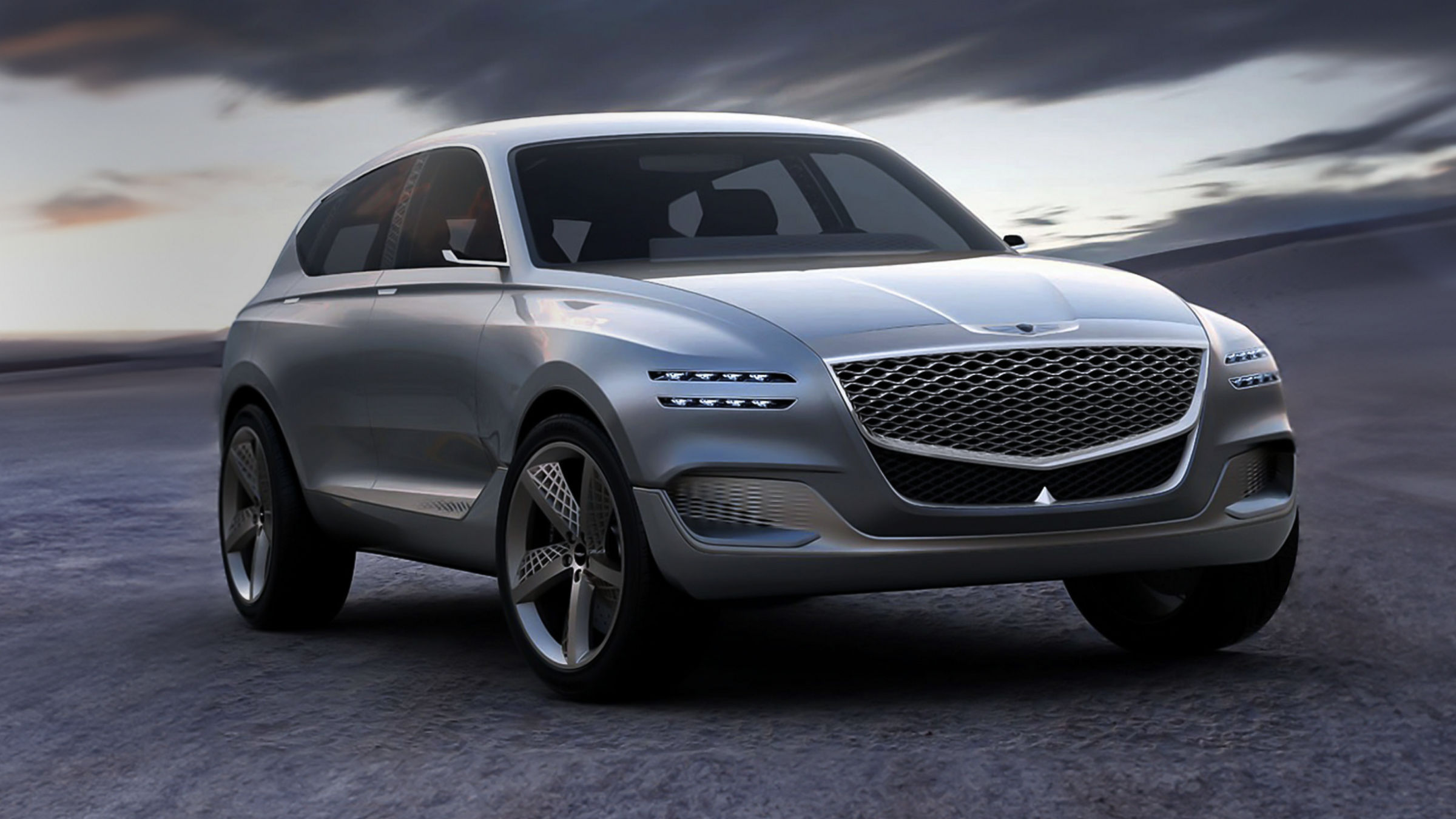 The front view of the Genesis GV80 Concept SUV, showcasing its bold grille and futuristic design