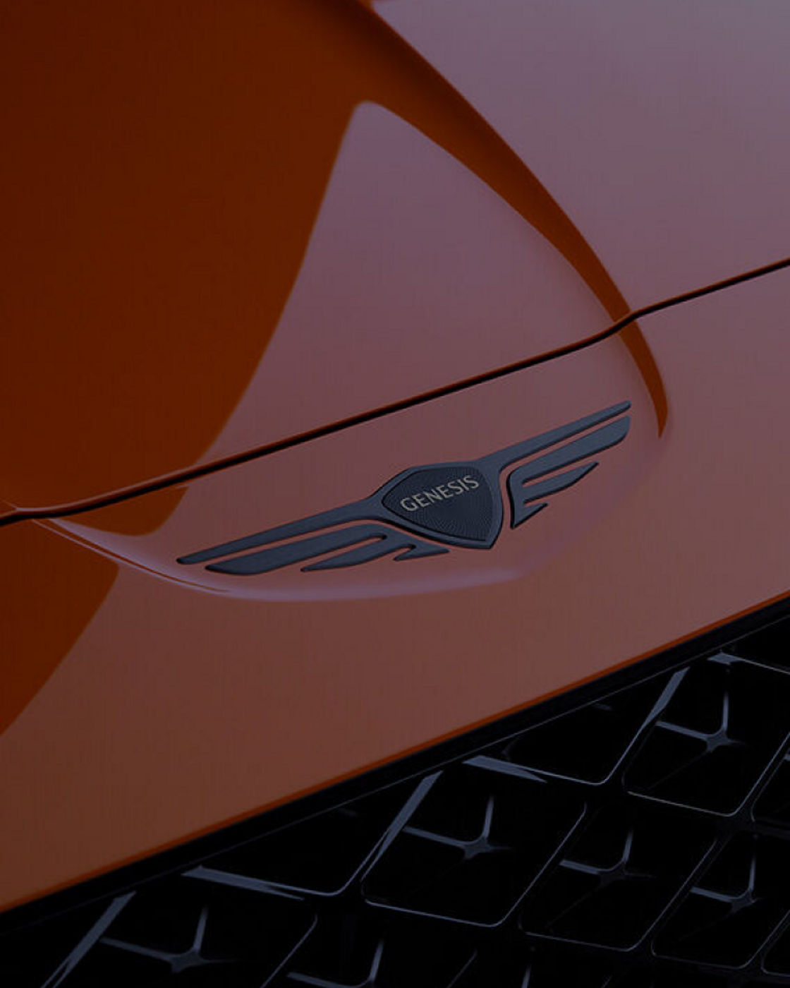 Genesis logo on an orange bonnet