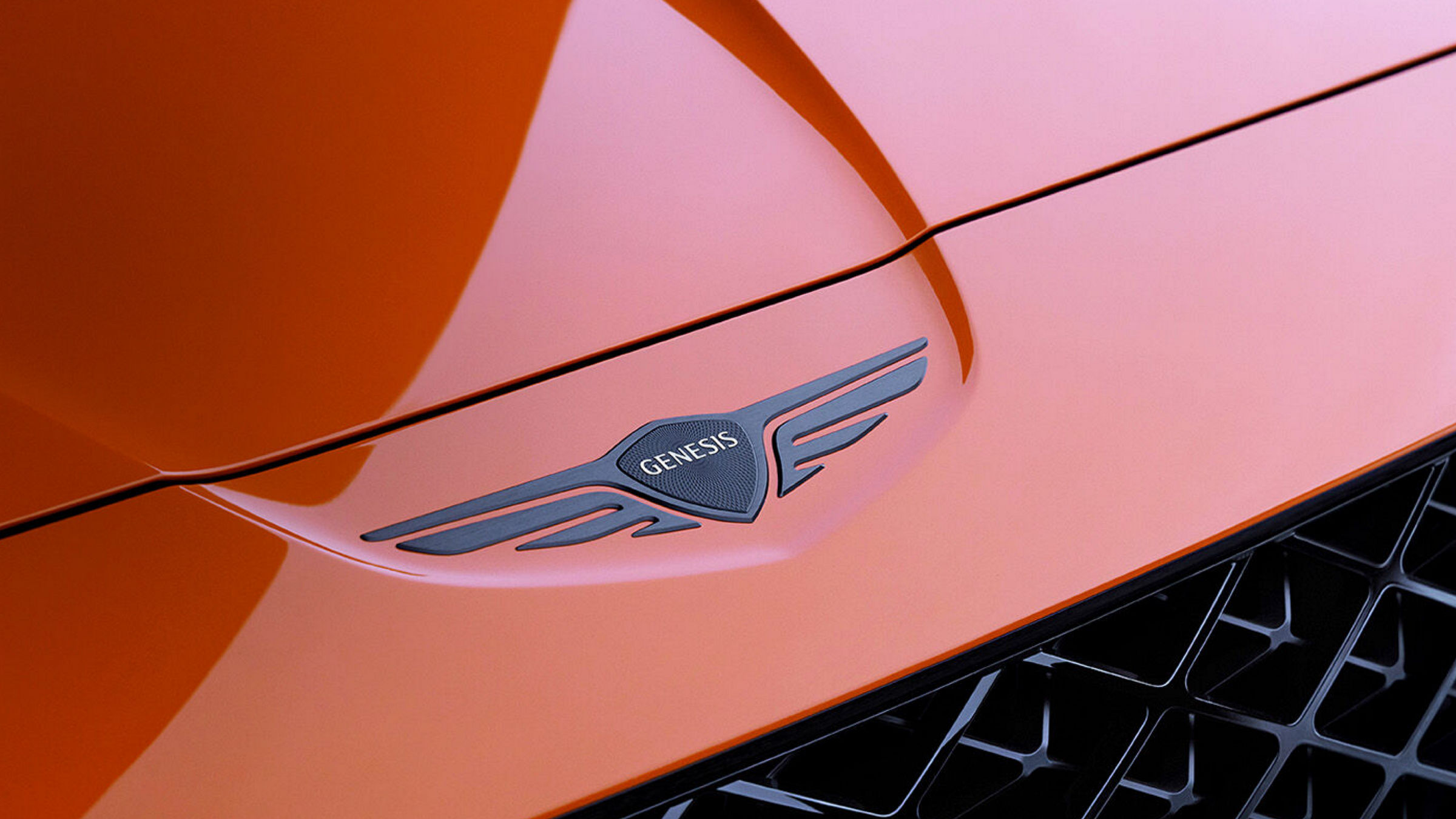 Genesis logo on an orange bonnet