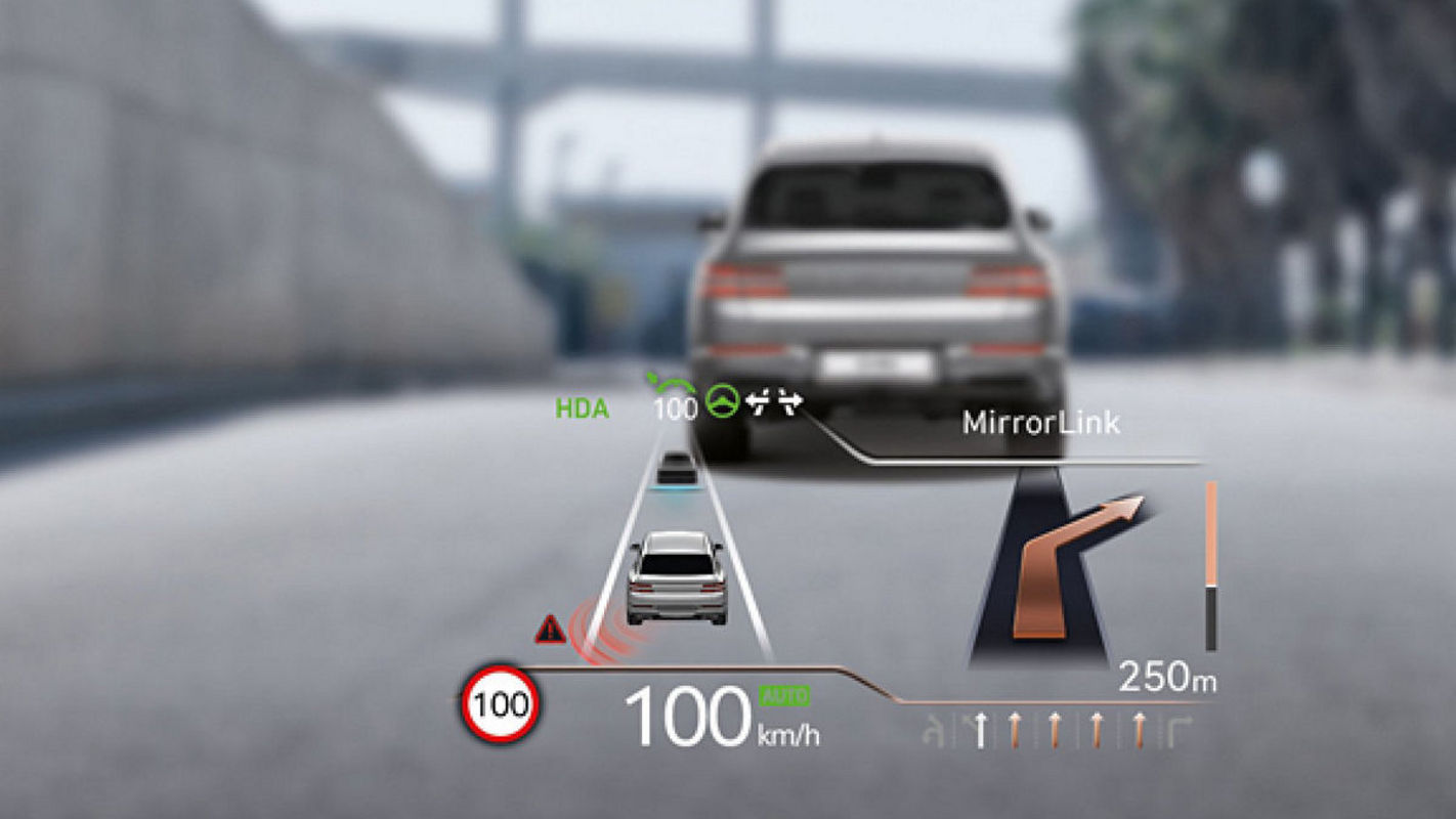 Heads-up display in the Genesis Electrified GV80 showing real-time navigation, speed, and adaptive cruise control information.