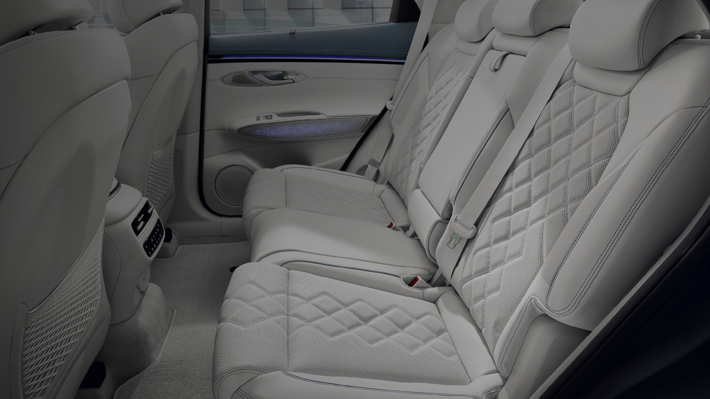 A view of the back seat from the open vehicle door. It has been neatly arranged.