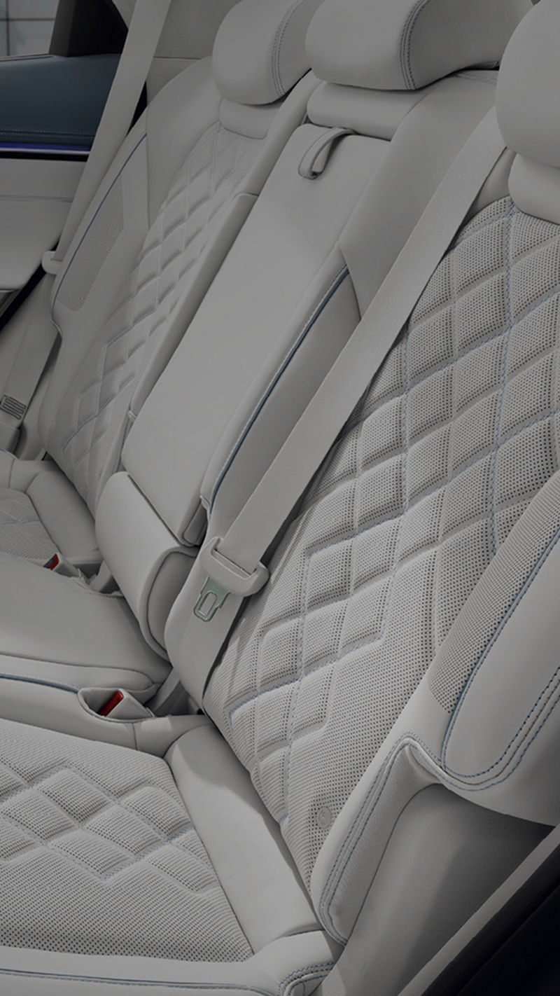 A view of the back seat from the open vehicle door. It has been neatly arranged.