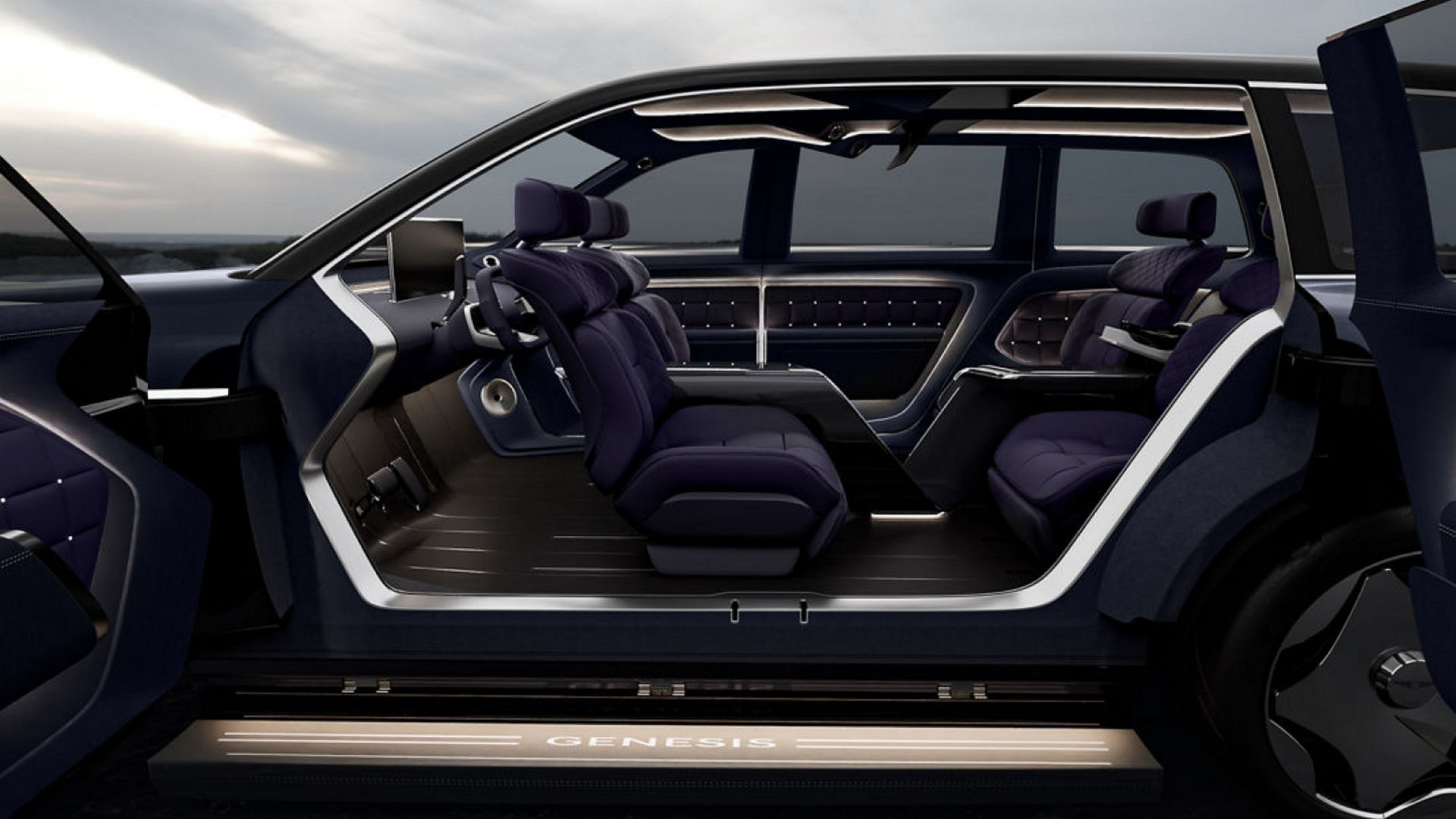 The Genesis neolun concept's interior is viewed from the side, with the front seat turned to face the rear seat with a cloudy sky in the background