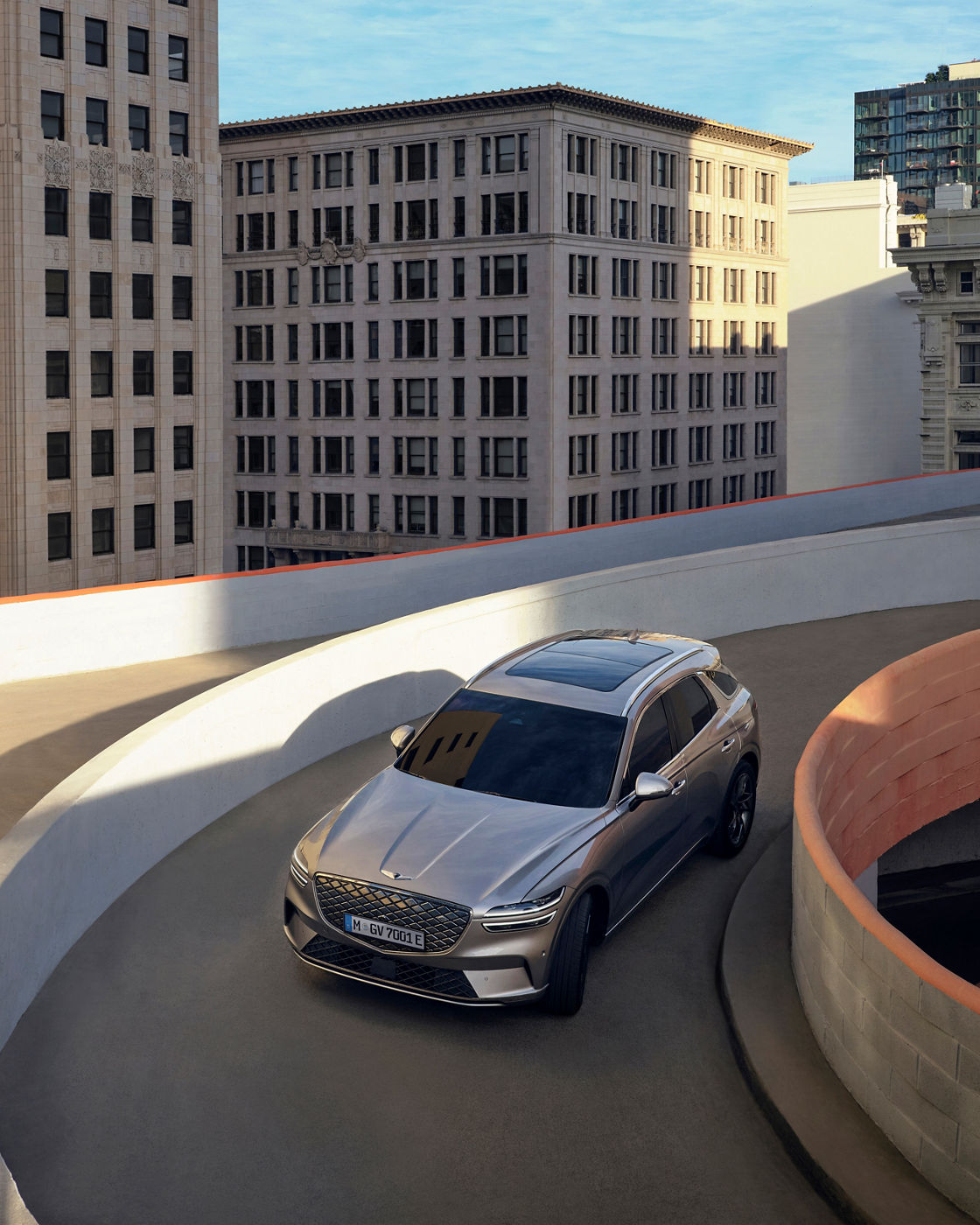 Grey Genesis GV70 drives down the ramp of a multi-storey car park