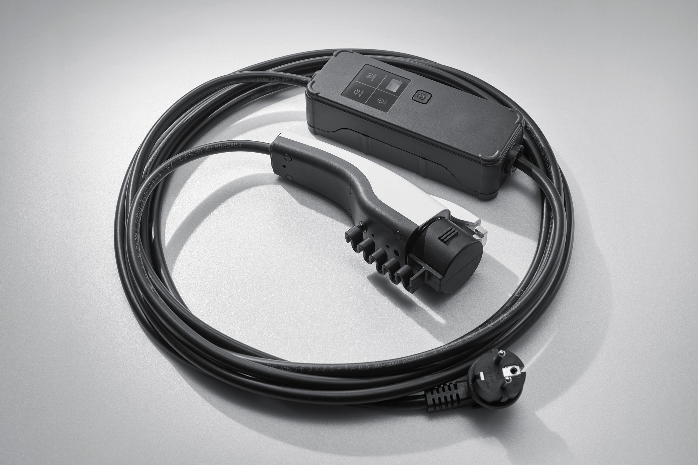 De kabel voor het opladen van een elektrische auto is opgerold in lussen.