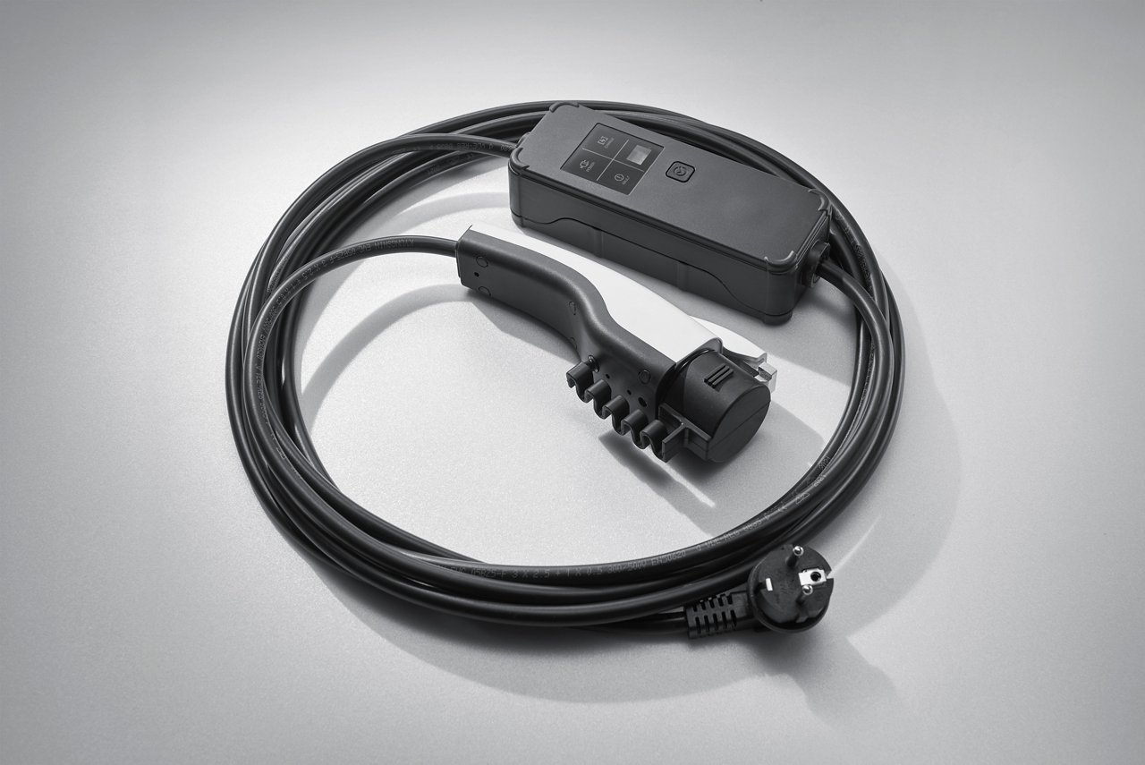 The cable for charging an electric car is coiled in rounds.