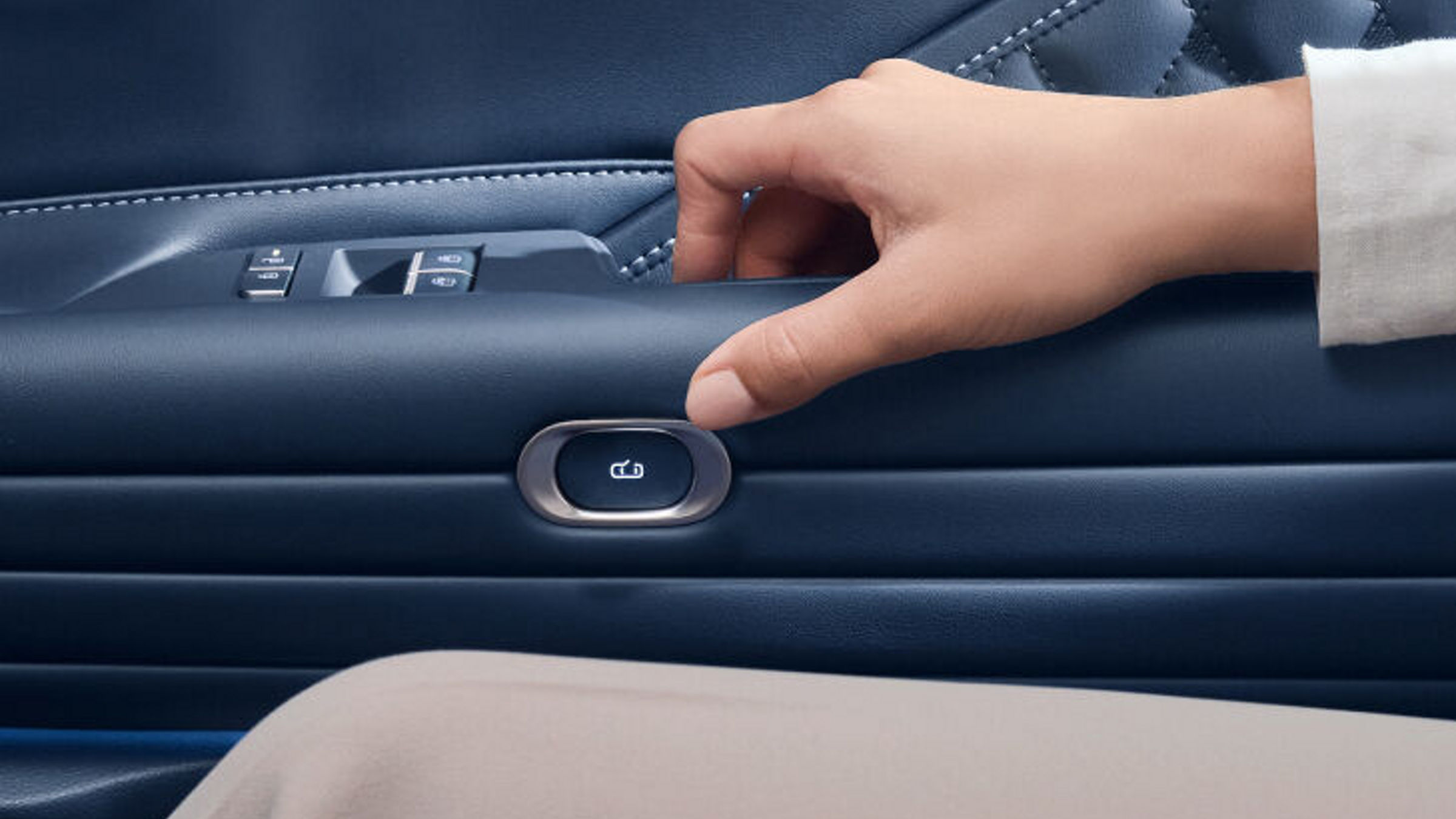 View the door trim button on the rear passenger door and the hand trying to press it.