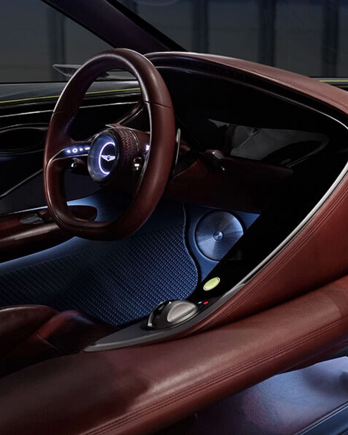 Detail of the steering wheel and dashboard in brown black from the Genesis X Concept