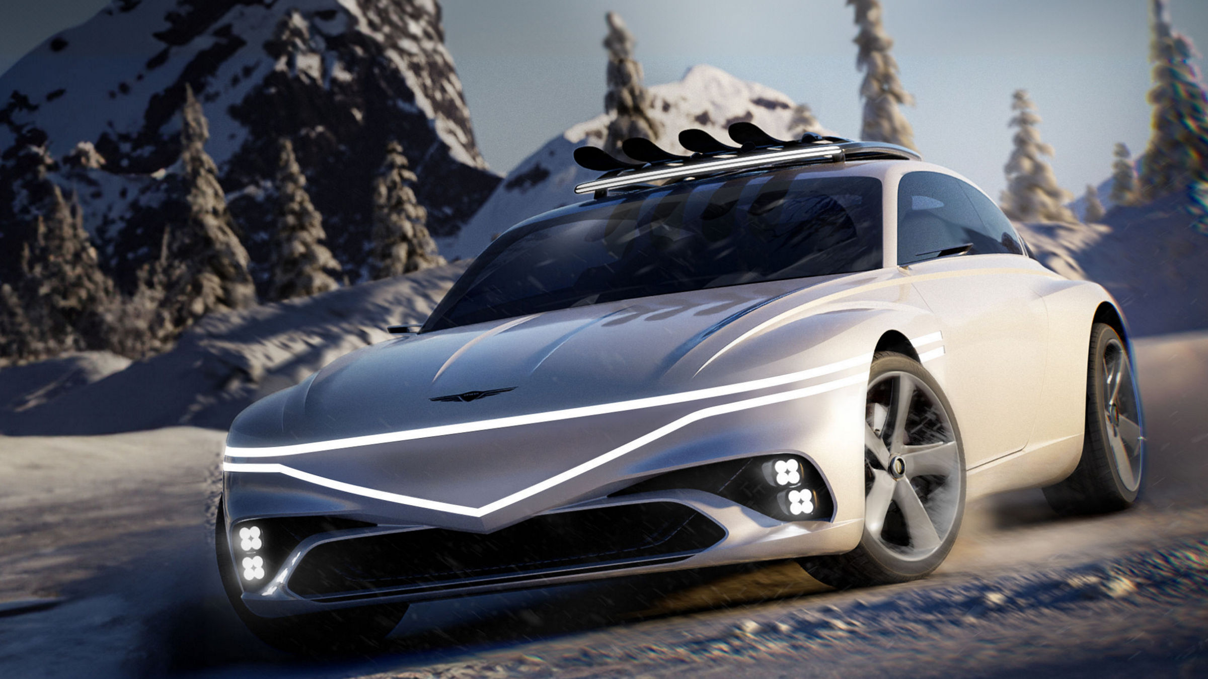 Genesis X Snow speedium concpet car sits stop a snowy mountain. Its front can be seen, with headlights lit up