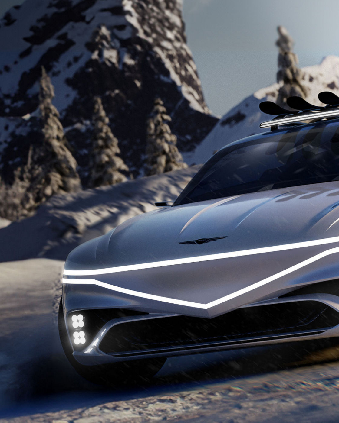 Genesis X Snow speedium concpet car sits stop a snowy mountain. Its front can be seen, with headlights lit up