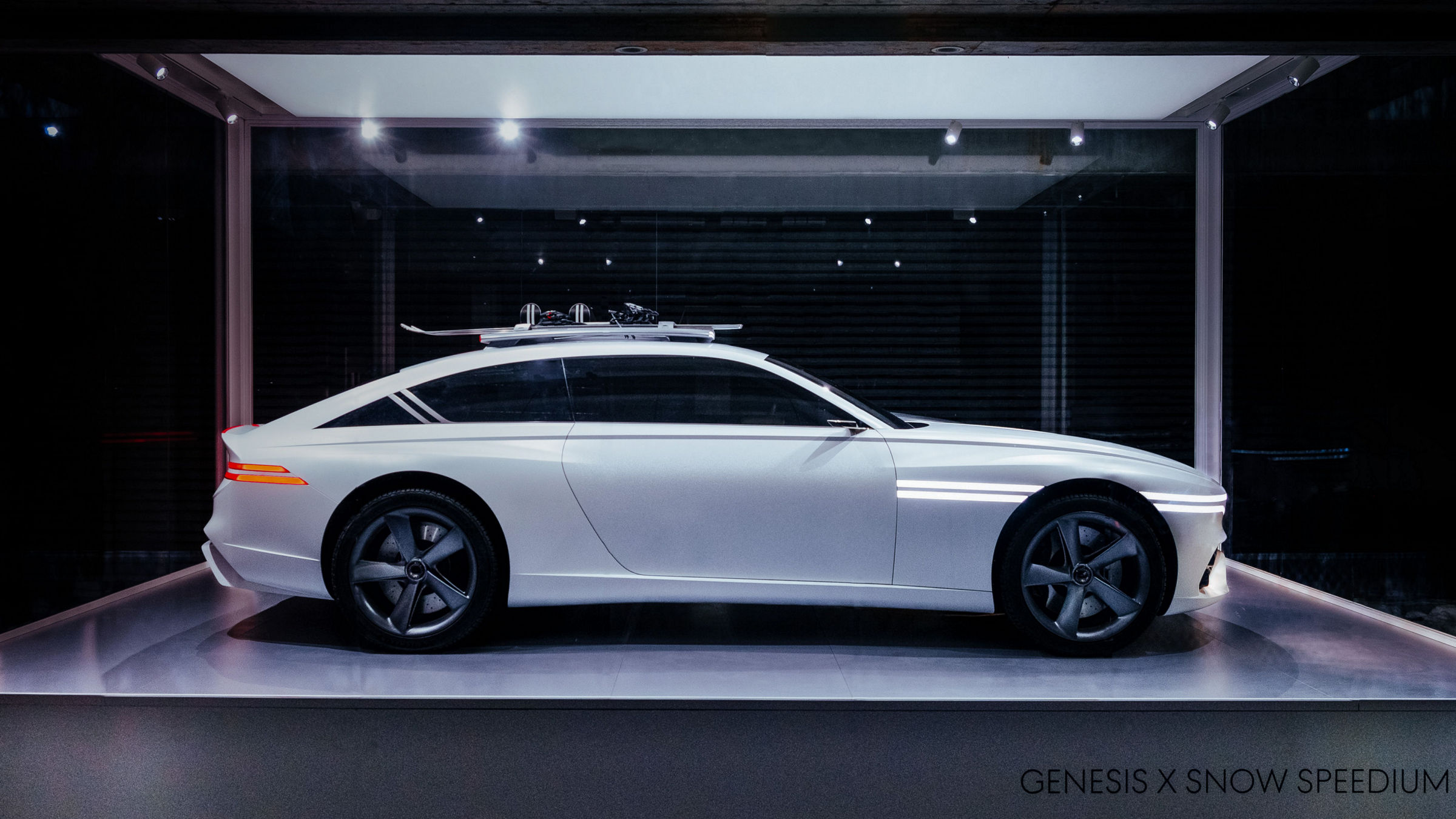 Genesis X Snow Speedium concept car is parked on top of a white pedestal.