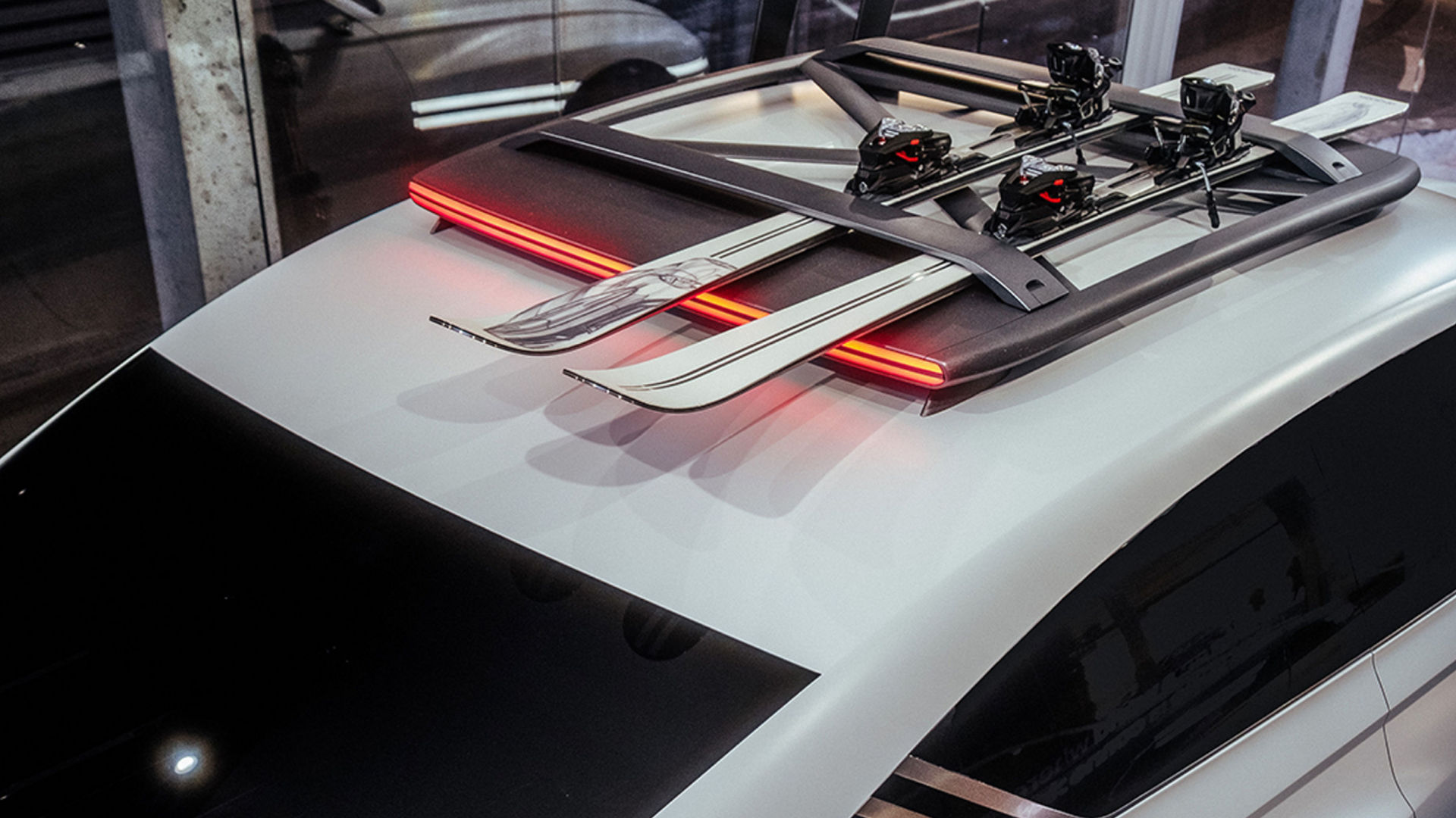 Skiis are atop the roof rack of the white-colored Genesis X Snow Speedium concept car.