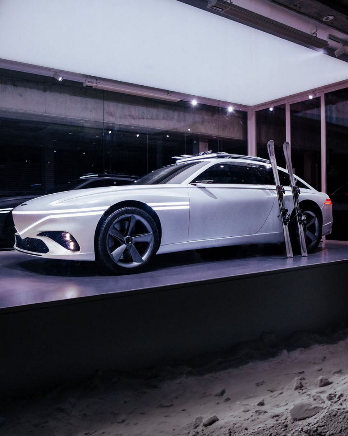 The white-colored X Snow Speedium concept vehicle with the lights turned on