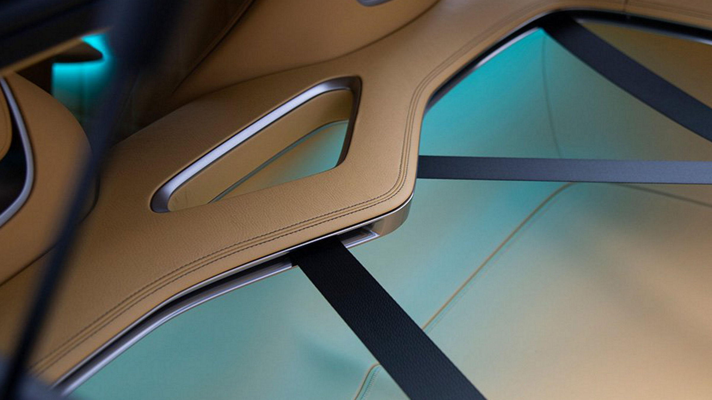 Interior detail of the Genesis X Speedium Concept, highlighting its innovative seat belt design and ambient lighting