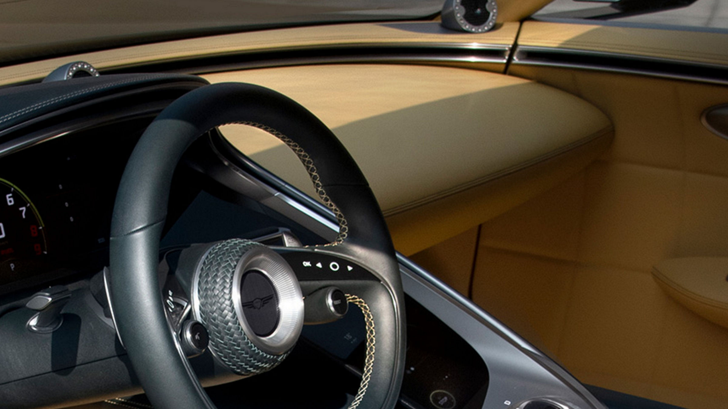 Close-up of the Genesis X Speedium Concept steering wheel, showcasing intricate design and luxurious materials