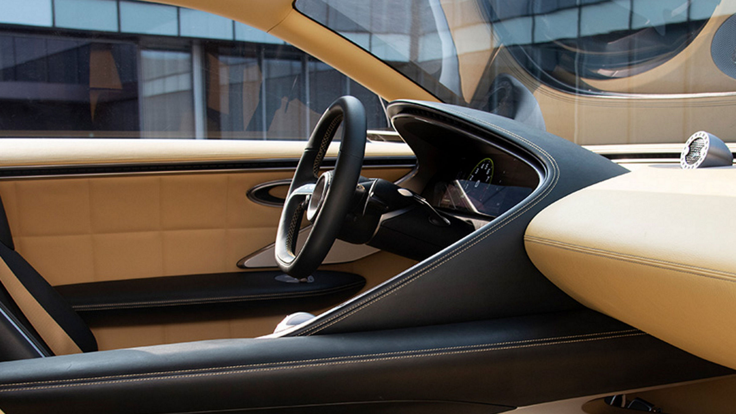 Interior view of the Genesis X Speedium Concept, highlighting the luxurious dashboard and steering wheel design