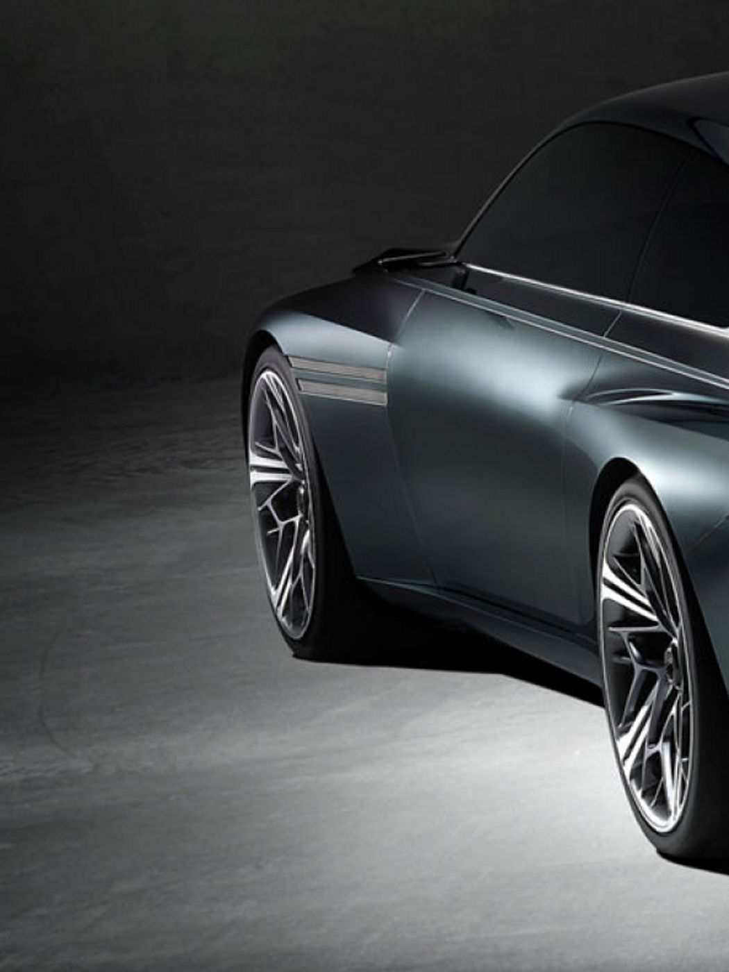 Rear quarter view of the Genesis X Speedium Concept, showcasing its aerodynamic lines and elegant design