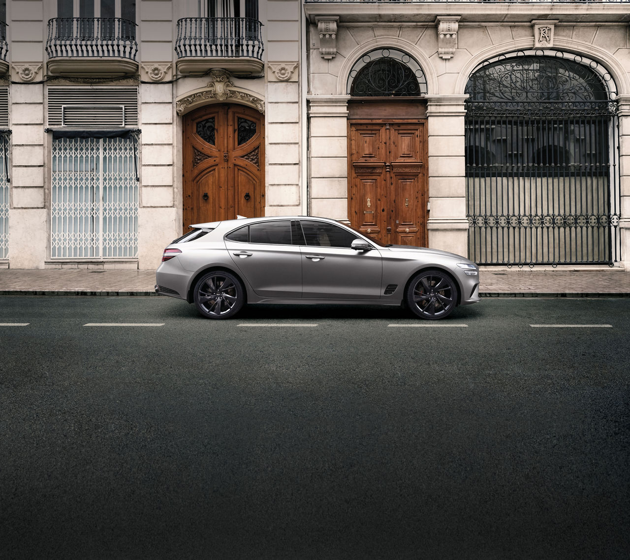 Genesis G70 Shooting Brake in silver is parking outdoor in front of a house facade