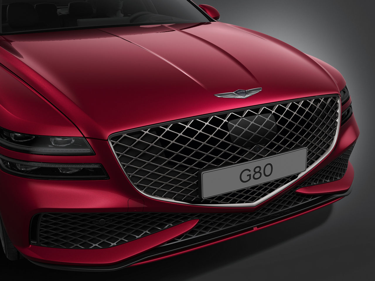 Genesis G80 Sport rouge - vue de face - calandre noire chromée brillante