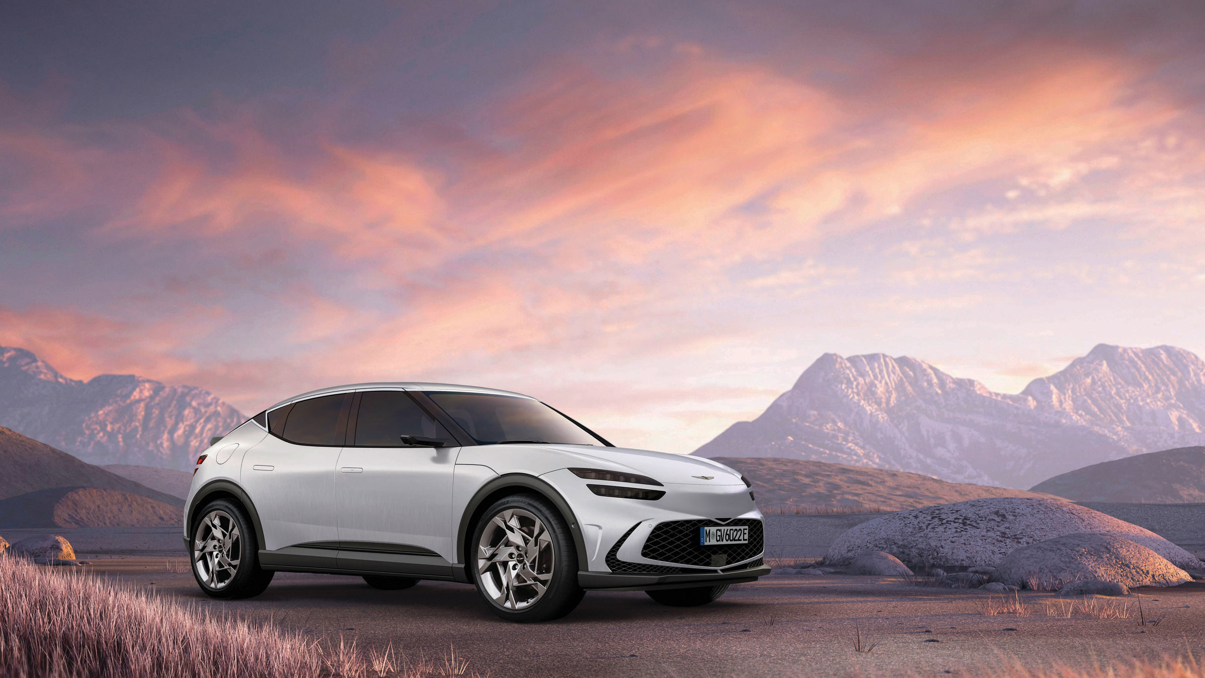 White Genesis GV60 with mountains in the background