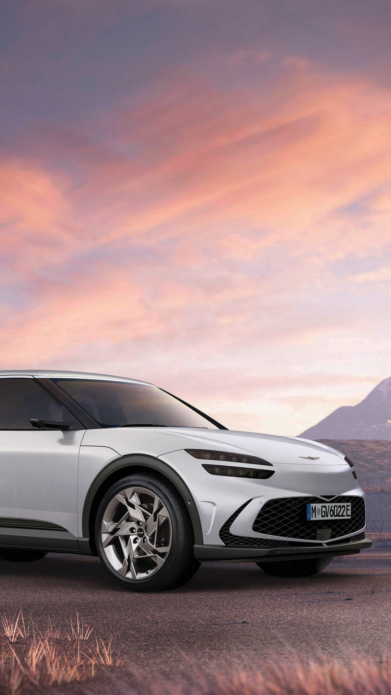 White Genesis GV60 with mountains in the background